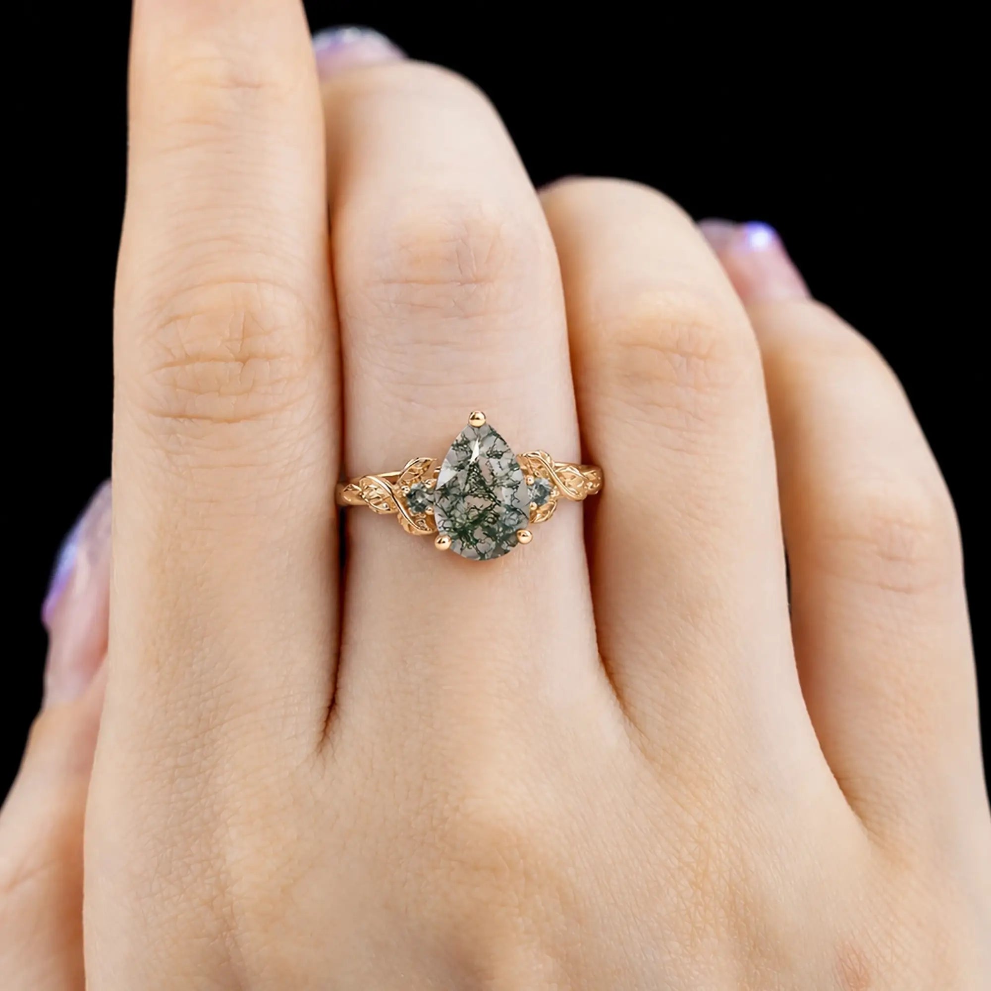 Pear moss agate leaf ring worn on hand with elegant botanical design