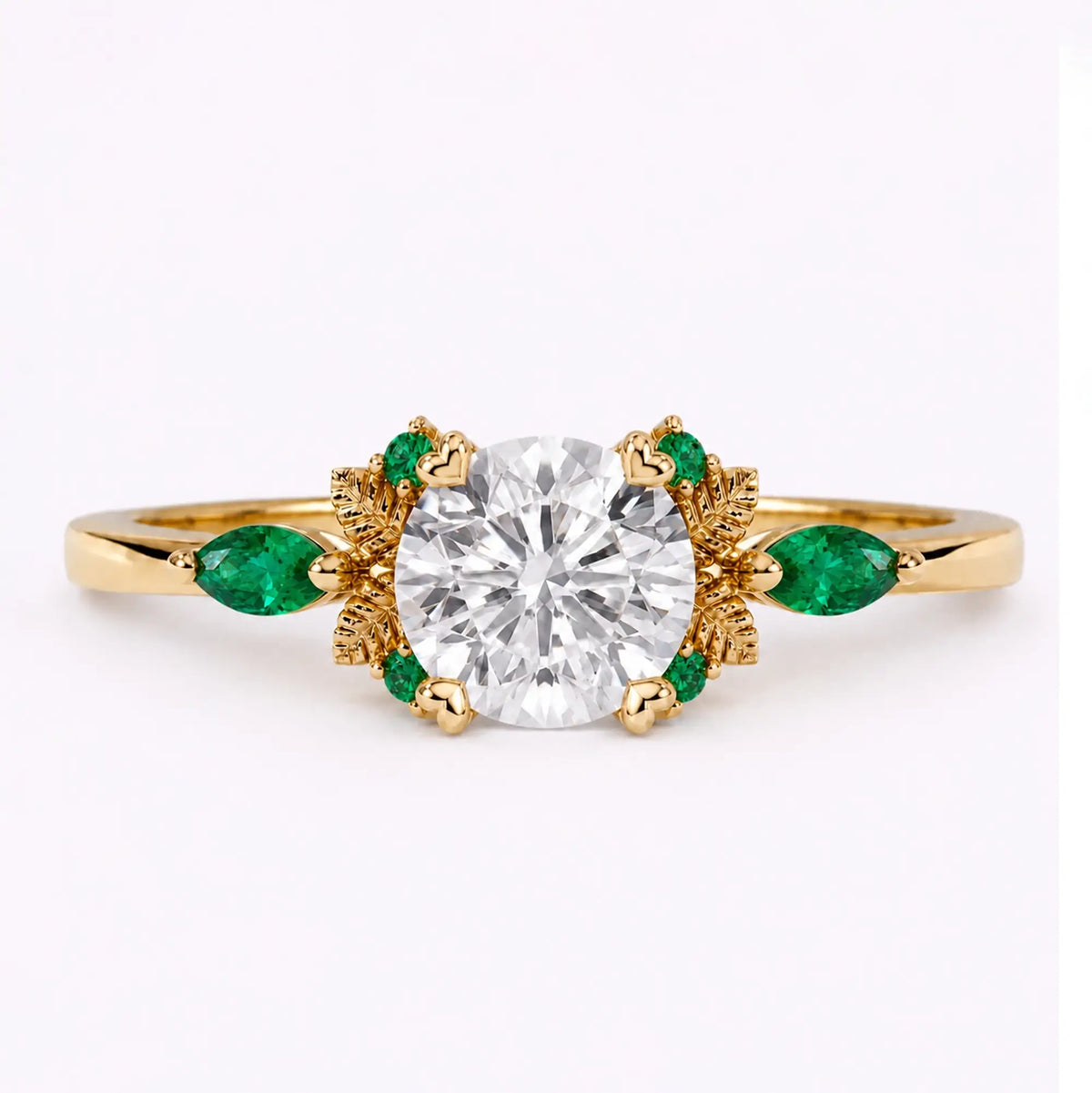 Round cut moissanite leaf engagement ring with emerald accents in yellow gold