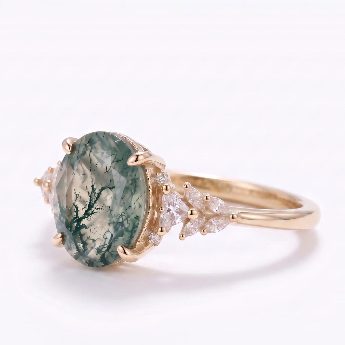Left angle of moss agate cluster ring with marquise, triangle, and round moissanite accents