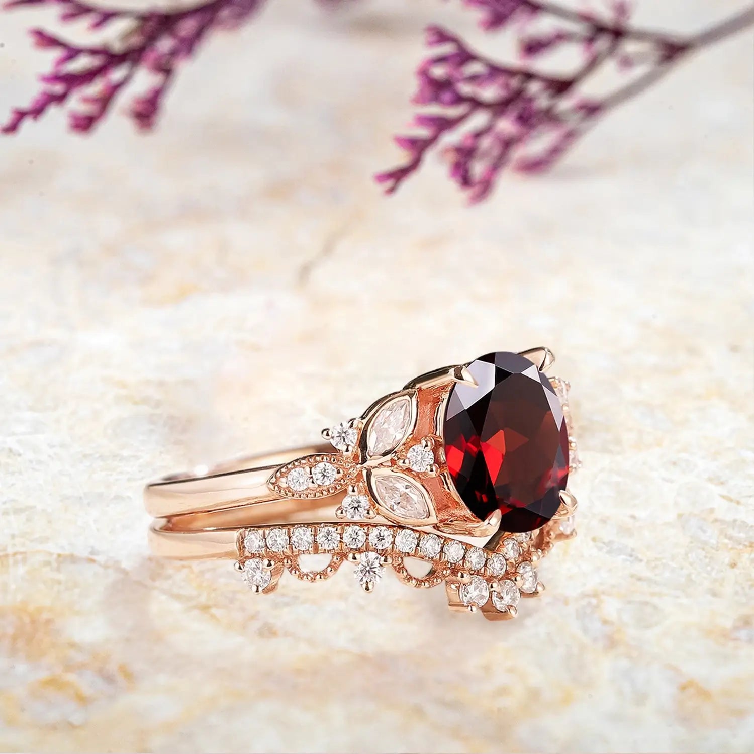 Side view of oval garnet ring showing floral cluster and pavรฉ band
