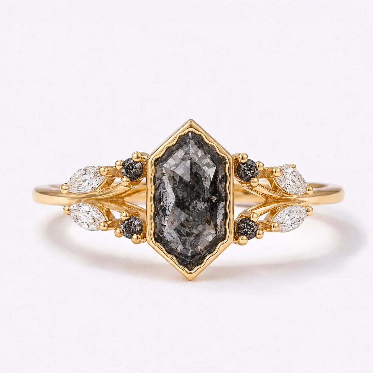 Elongated hexagon salt and pepper diamond bezel ring with leaf accents in yellow gold