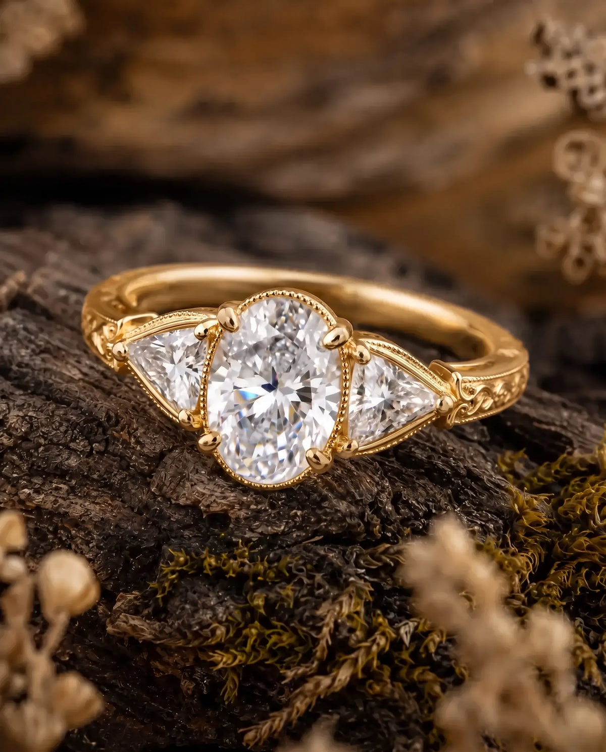 Ornate scrollwork and engraved shoulder detail on a vintage-inspired moissanite engagement ring