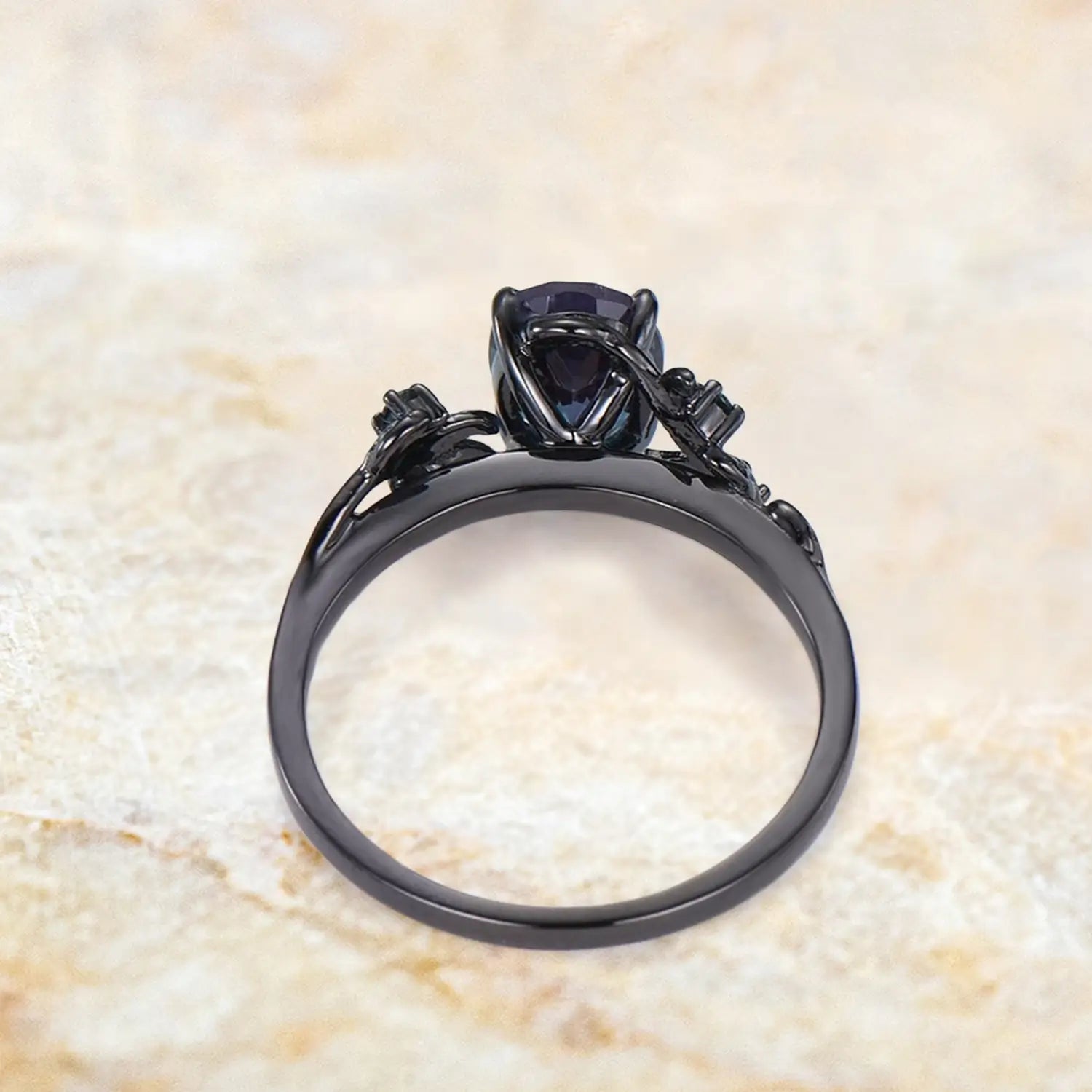 Close up detail of oval alexandrite center stone with nature inspired twig branch and round alexandrite accents