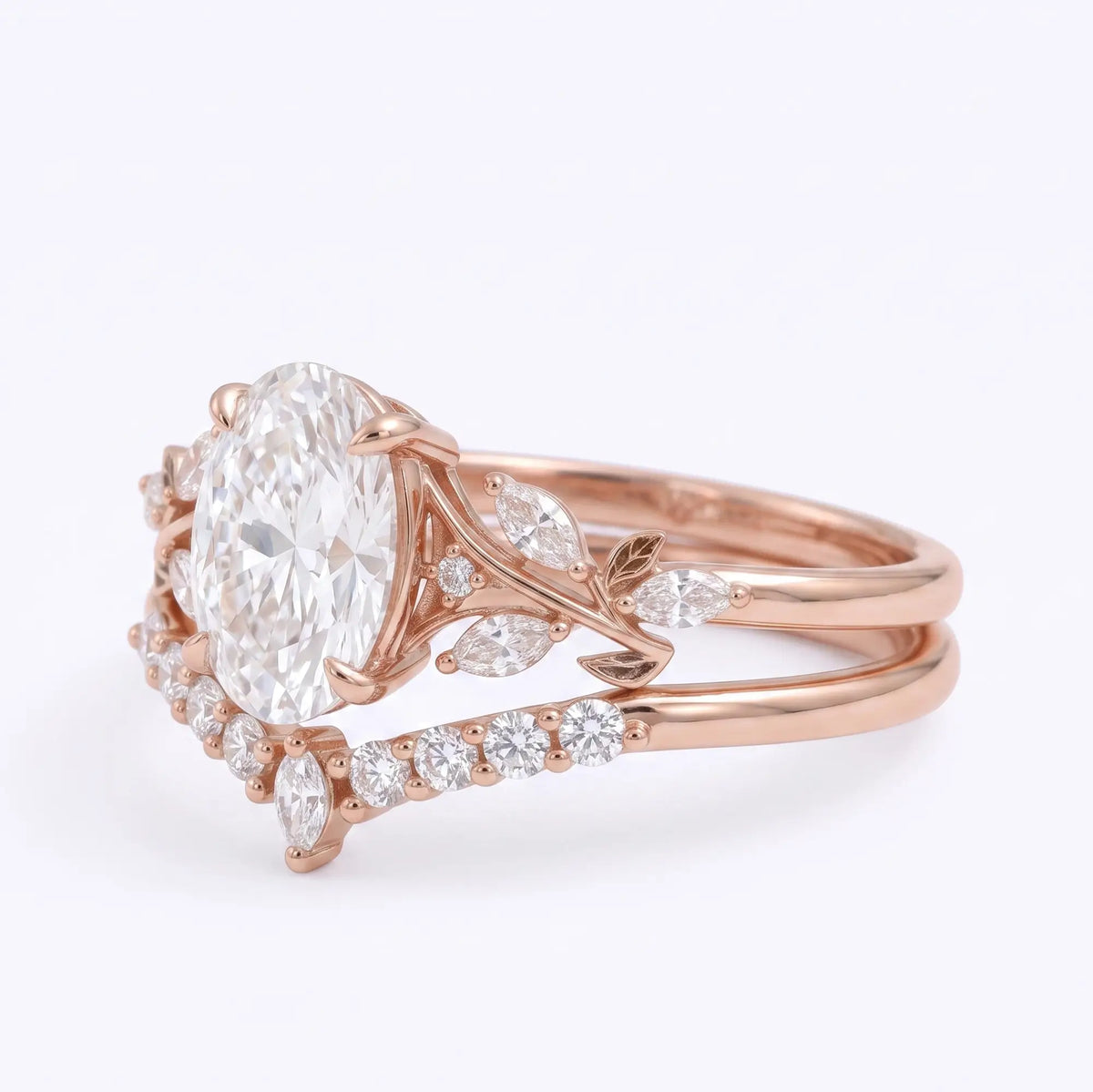 Nature inspired oval moissanite engagement ring set with marquise leaf accents left view