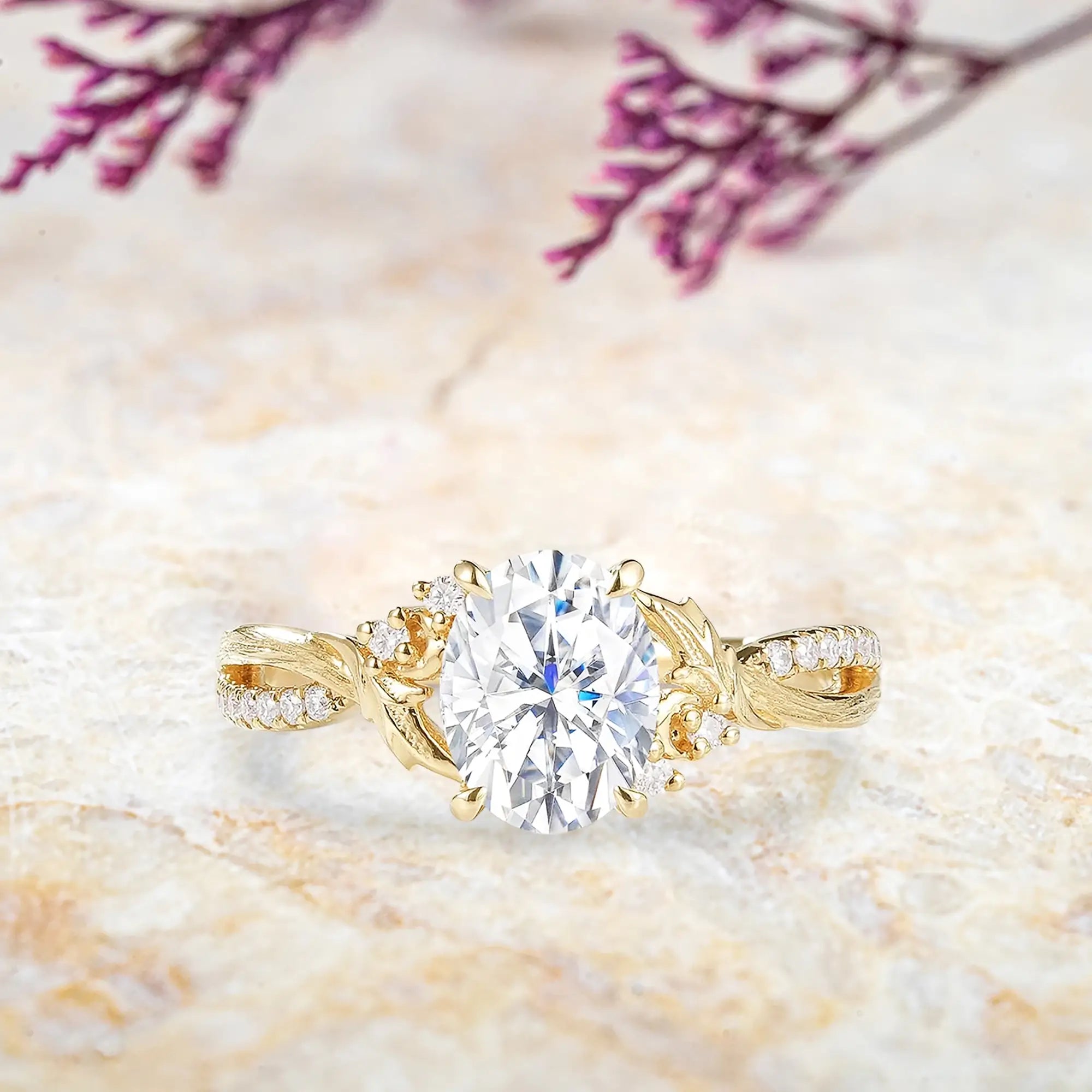 Oval moissanite engagement ring in yellow gold with leaf accents and tree bark texture