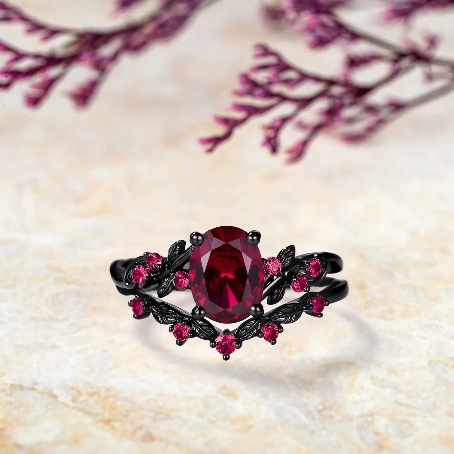 Orleone Oval ruby engagement ring with black rhodium gold leaf band and matching curved wedding band set