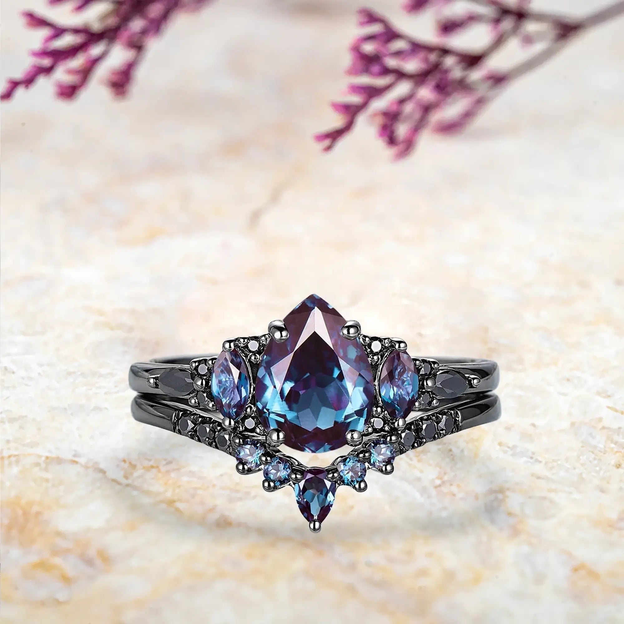 Pear alexandrite engagement ring with black moissanite marquise cluster and chevron wedding band set in black gold