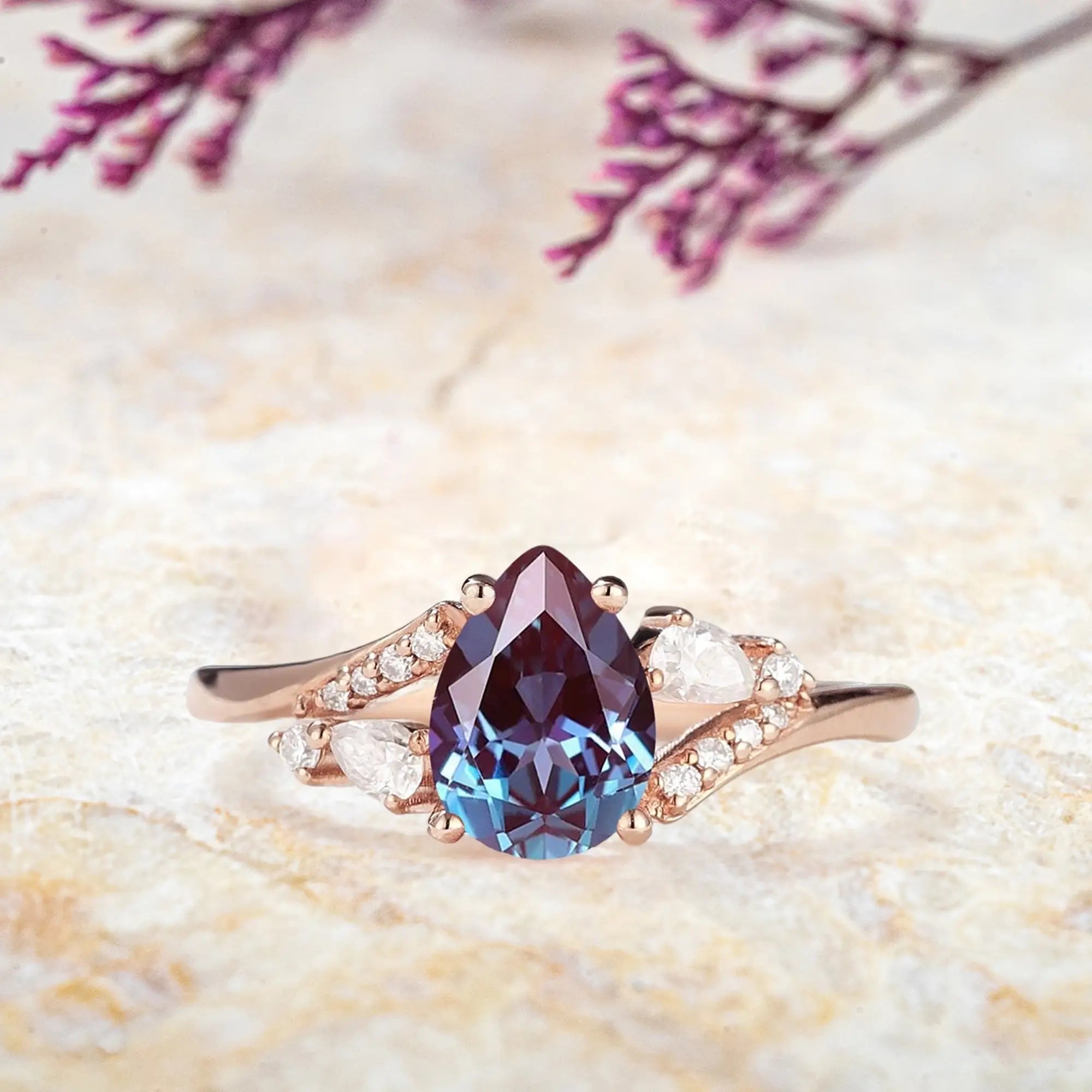 Pear alexandrite engagement ring in rose gold with moissanite cluster celestial design