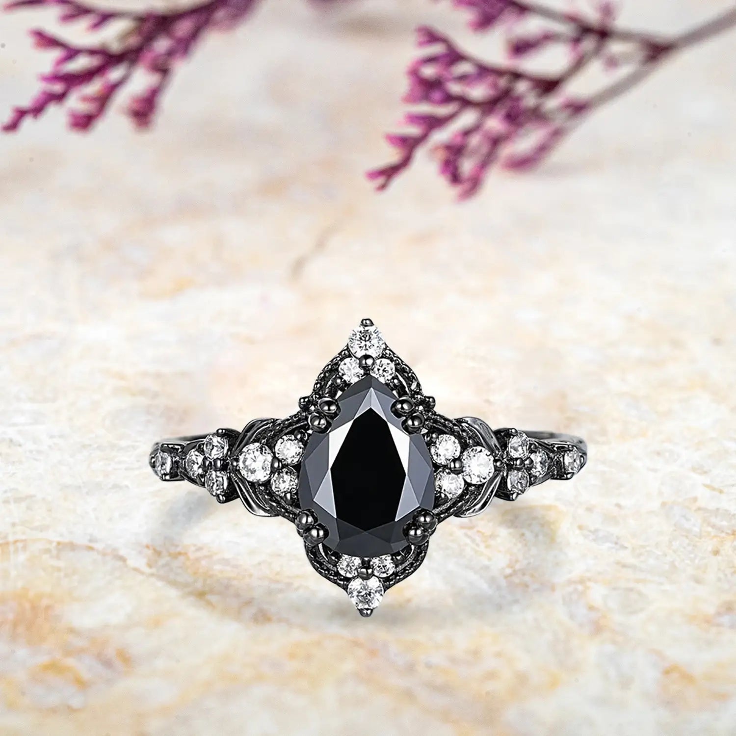 Pear black onyx engagement ring with leaf crown milgrain halo and chevron diamond wedding band in black gold