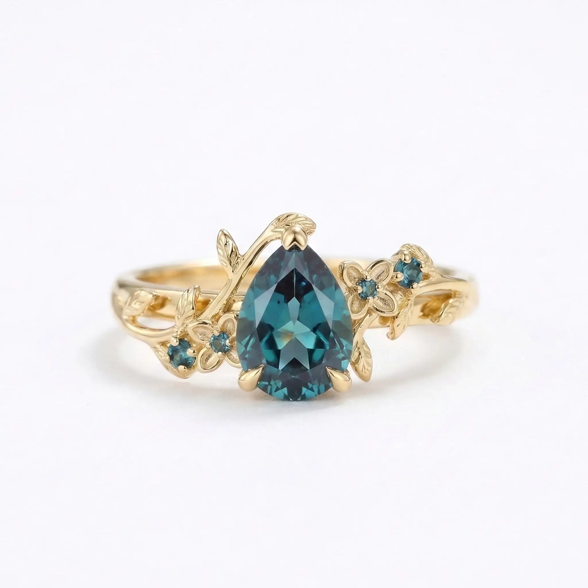 Pear cut alexandrite engagement ring with floral leaf band