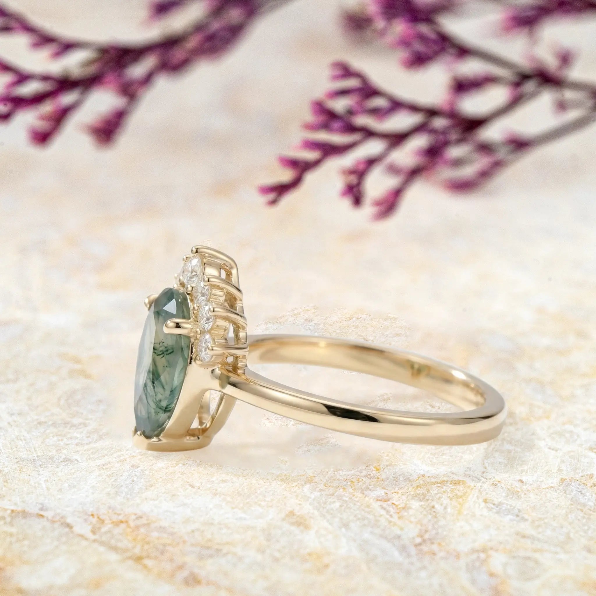Side view of moss agate half-halo ring showing yellow gold band and crown details left view