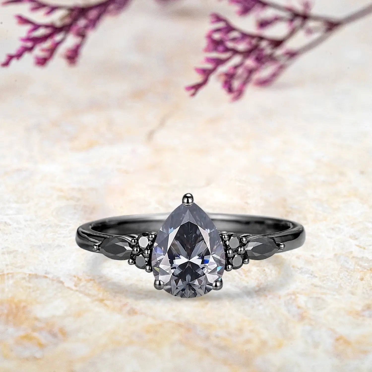 Pear gray moissanite engagement ring with black moissanite marquise cluster and onyx sunburst wedding band