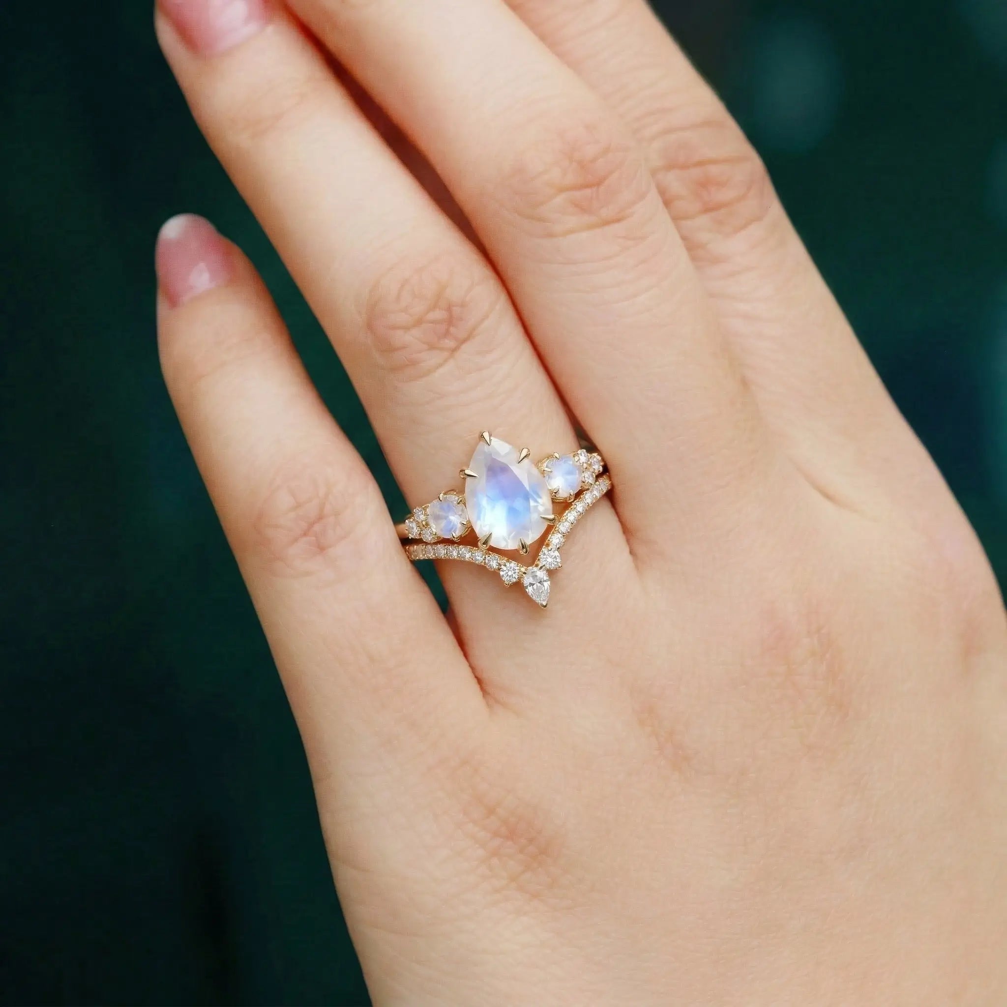 pear cut moonstone cluster engagement ring with round moonstone side stones and moissanite pave curved wedding band bridal set for women