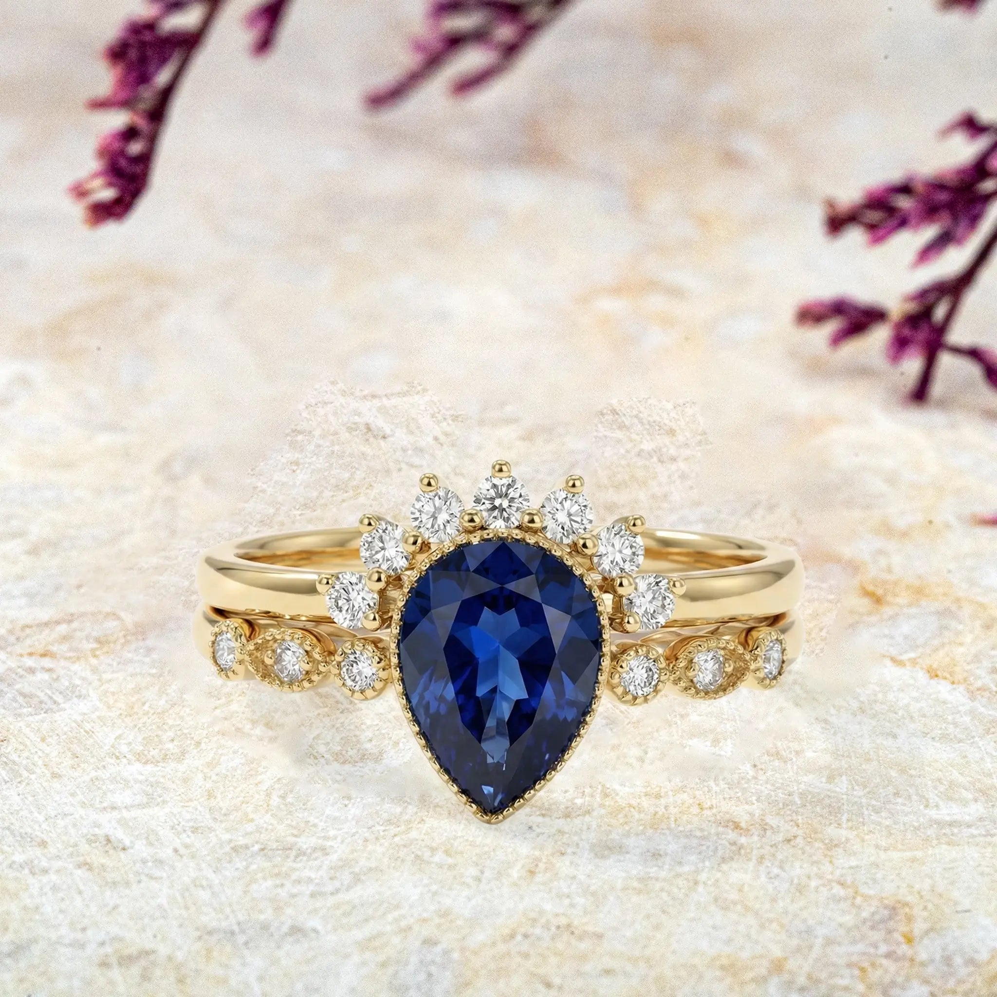 Pear cut sapphire ring set with milgrain bezel and moissanite accents in gold