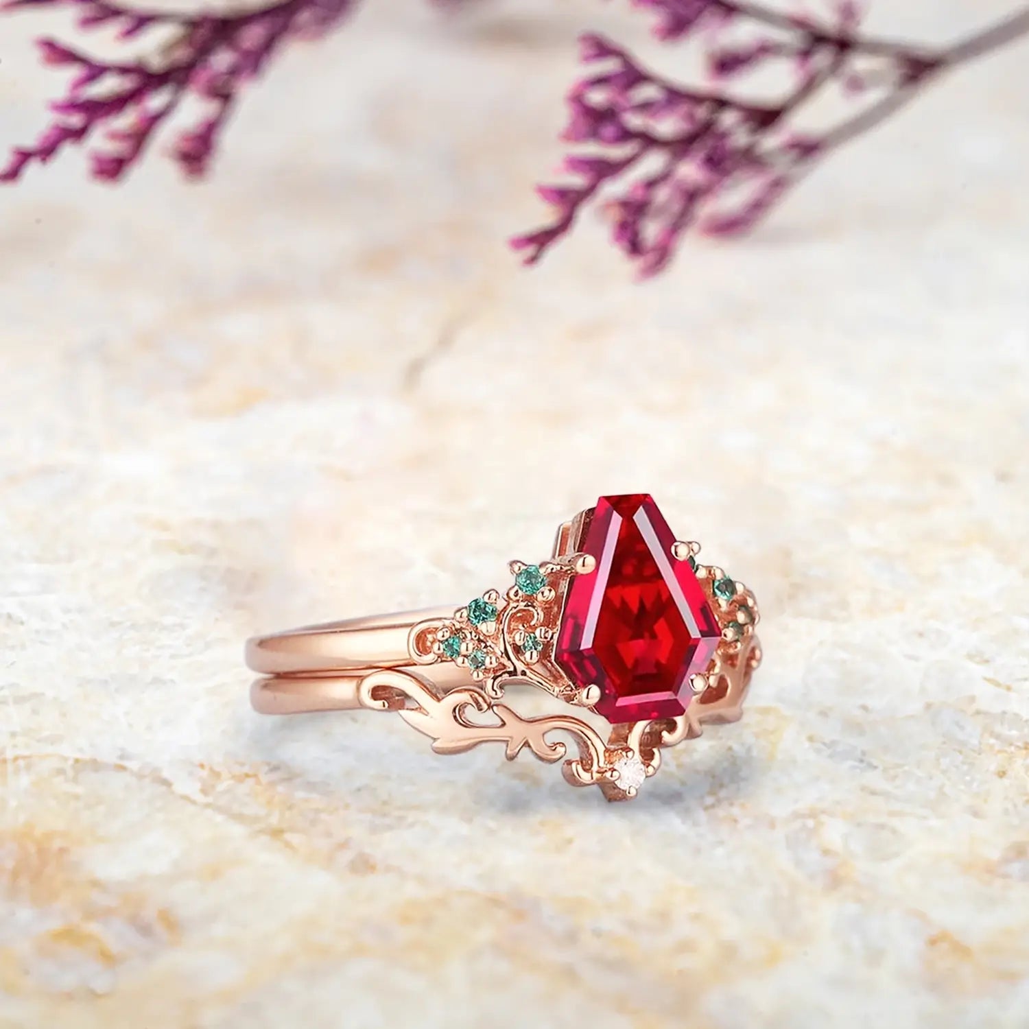 Unique coffin-cut ruby engagement ring with emerald leaves and coral filigree