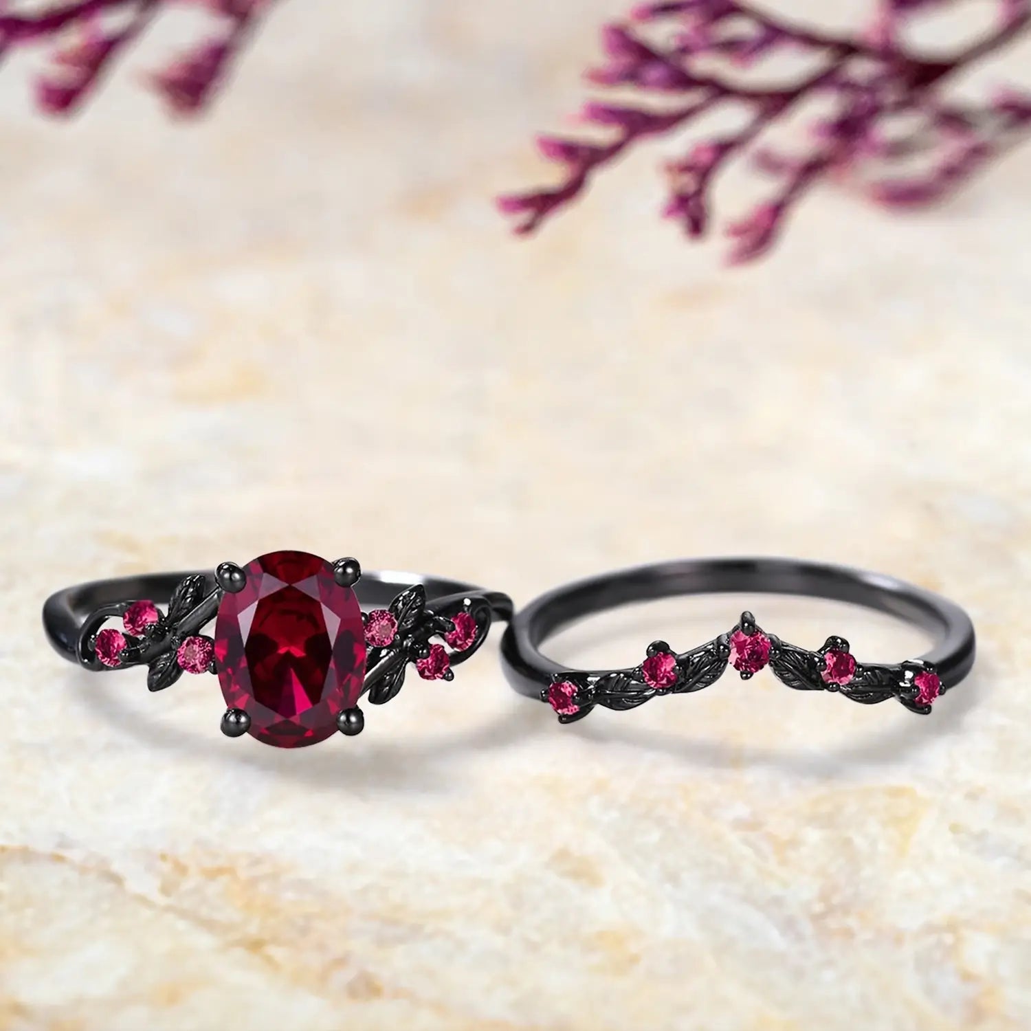 Oval ruby engagement ring and curved wedding band displayed separately showing July birthstone bridal set