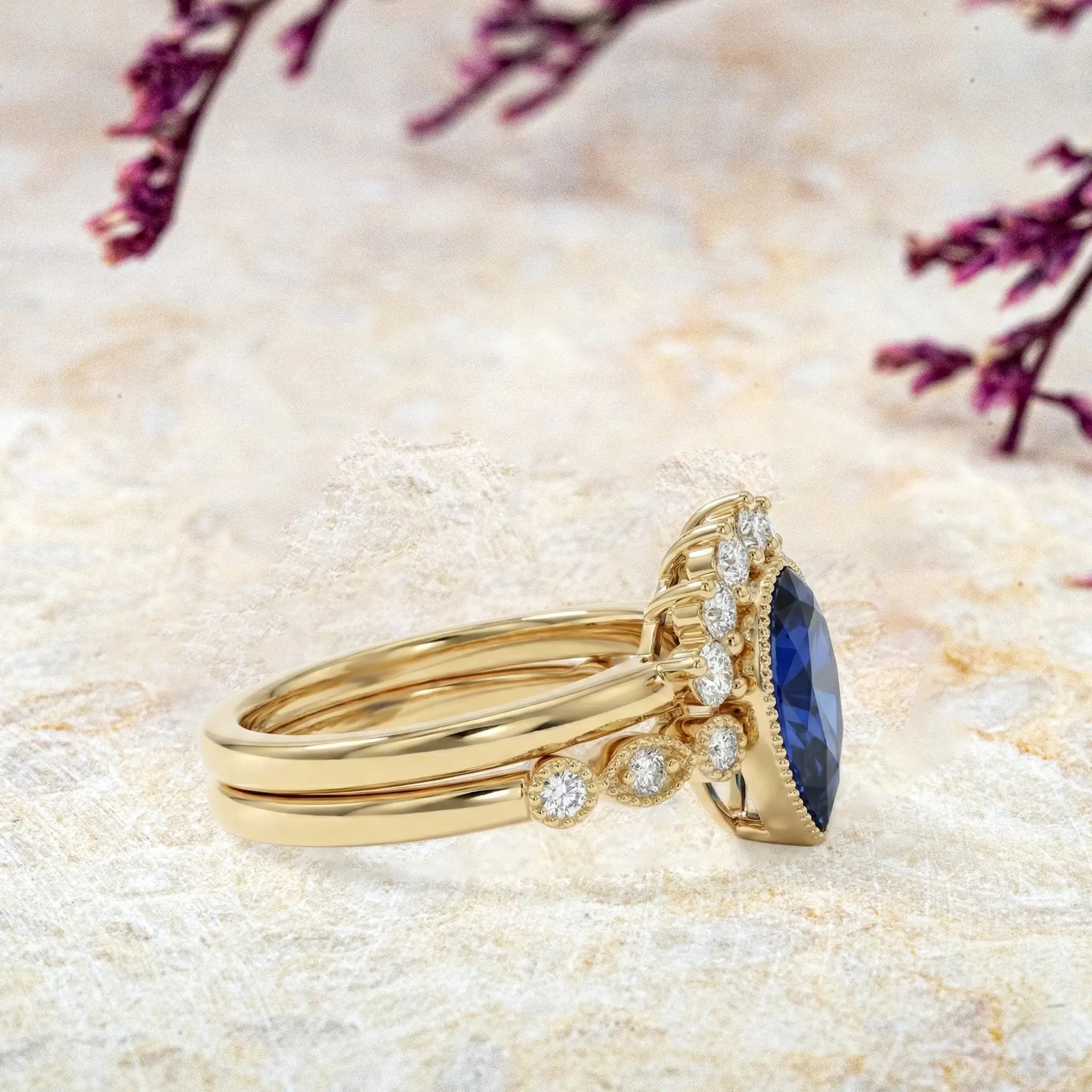 Side view of pear sapphire engagement ring with vintage milgrain detail
