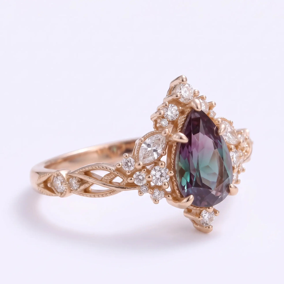 Right side view of Selviora Edwardian-inspired lab alexandrite halo ring highlighting the pear cut center stone, ornate cluster setting and twisted openwork band.