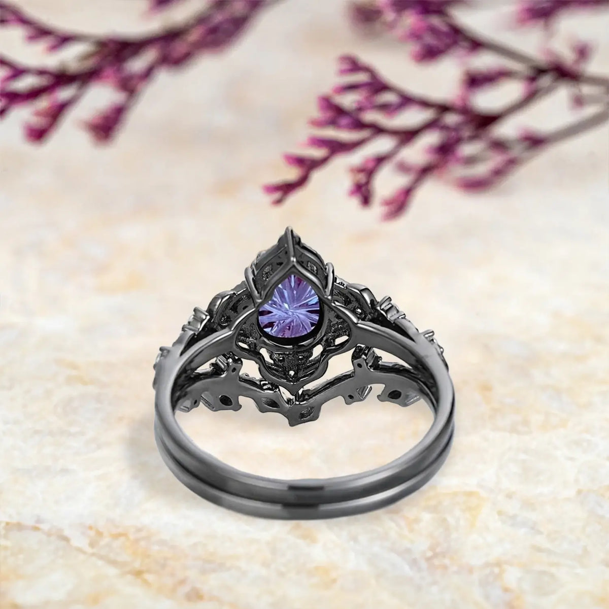 Back view of luxury alexandrite engagement ring set showing leaf inspired cluster and chevron wedding band craftsmanship in black gold