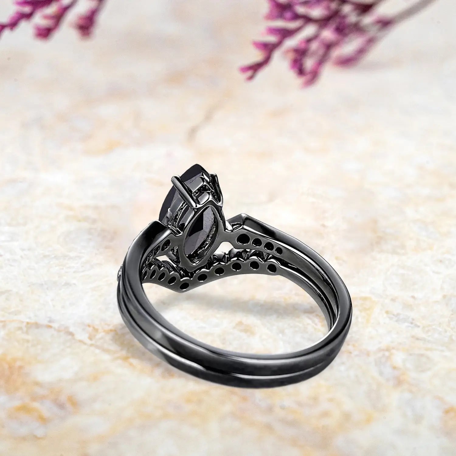 Back view of unique black onyx engagement ring set showing vintage milgrain and chevron wedding band craftsmanship in black gold