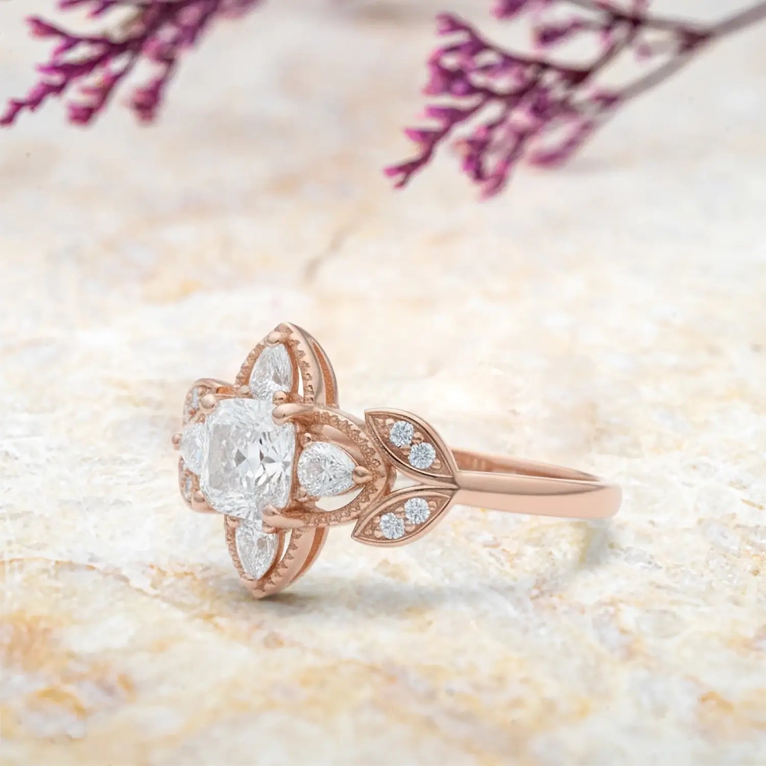 Side view of cushion moissanite ring showing four leaf clover halo with pear stones and vintage milgrain band profile