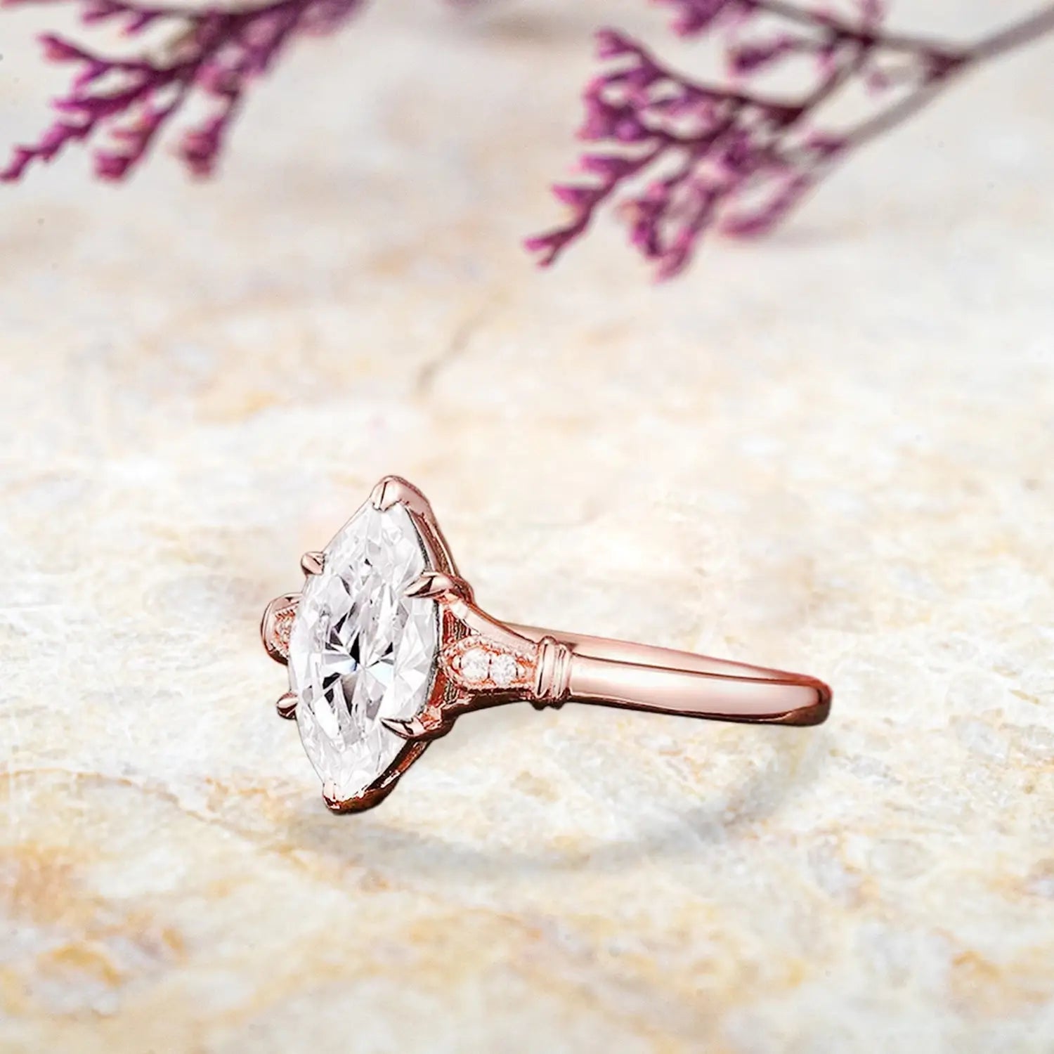 Side view of marquise moissanite ring showing pear accents and vintage split shank band profile