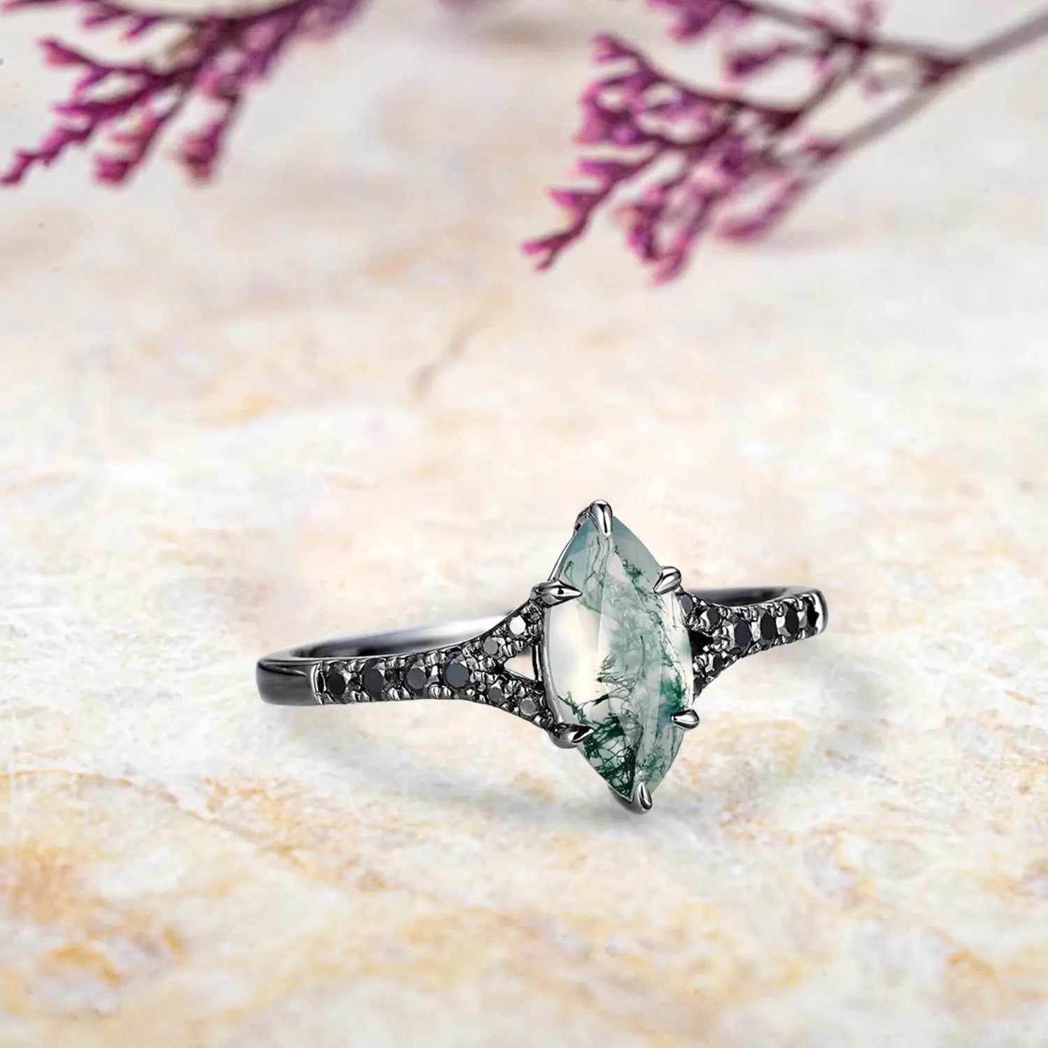 Side view of marquise moss agate ring showing nature inspired split shank design with black moissanite pavé