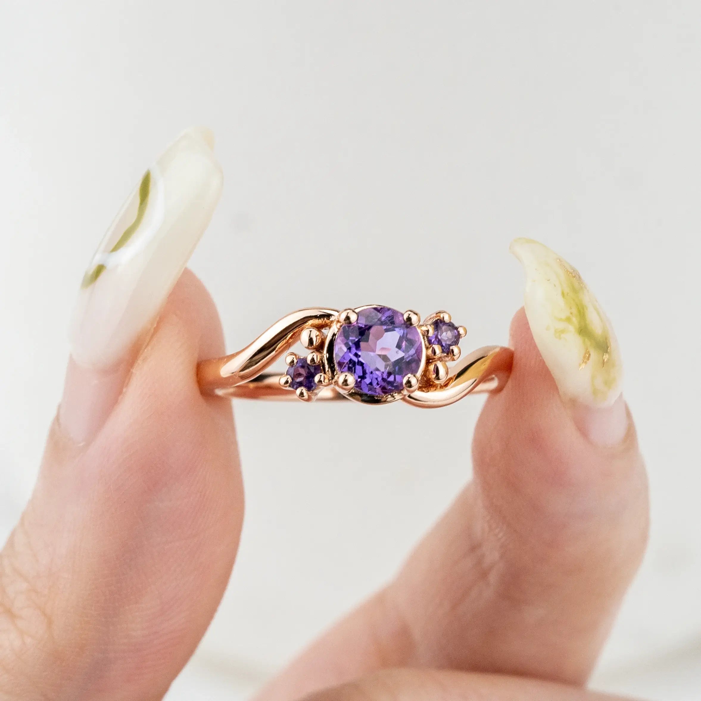 Twilight Amethyst Ring, featuring a natural round-cut amethyst and twisted gold band.