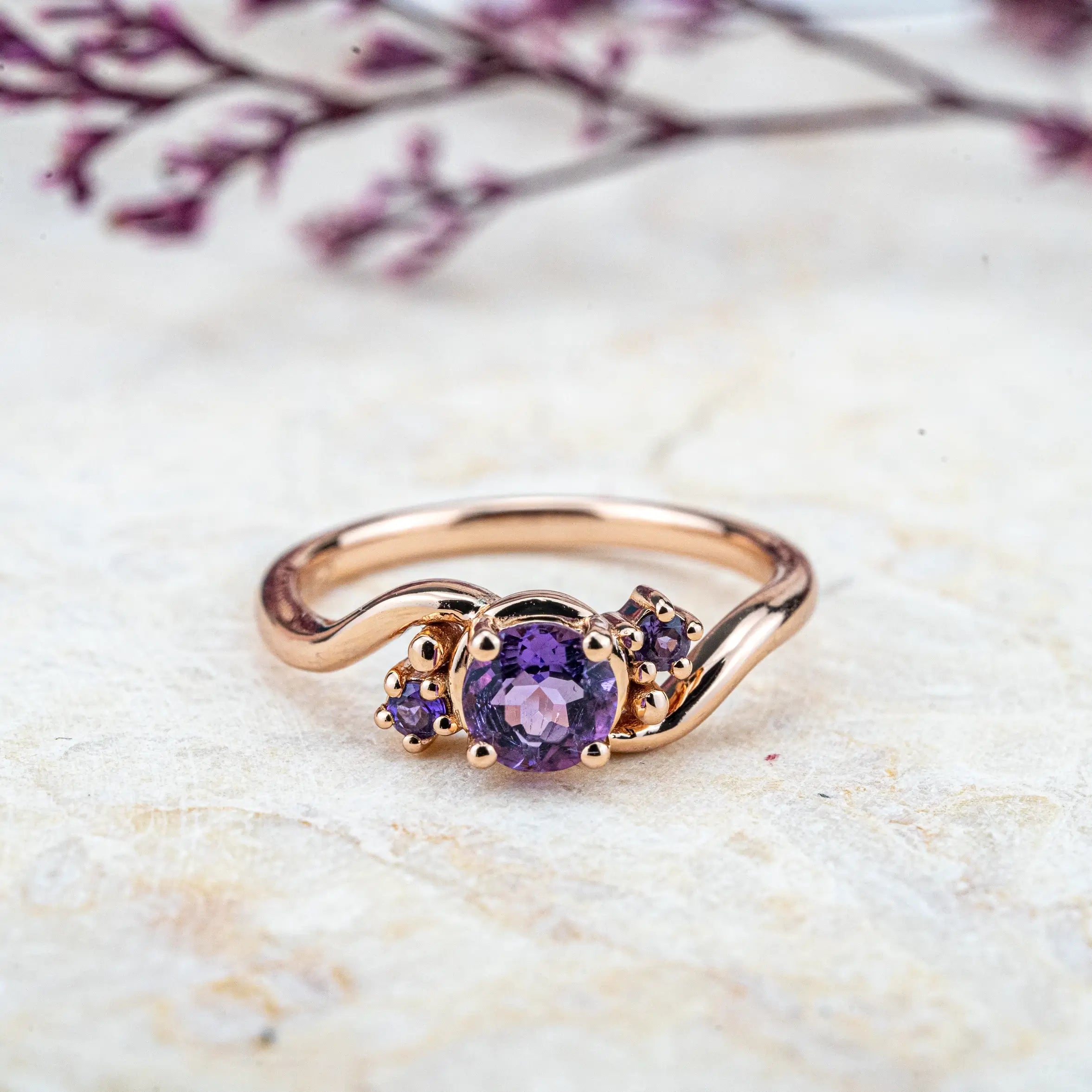 Twilight Amethyst Ring, featuring a natural round-cut amethyst and twisted gold band. Perfect as a minimalist engagement ring or elegant everyday piece, available in 14k/18k gold or platinum.