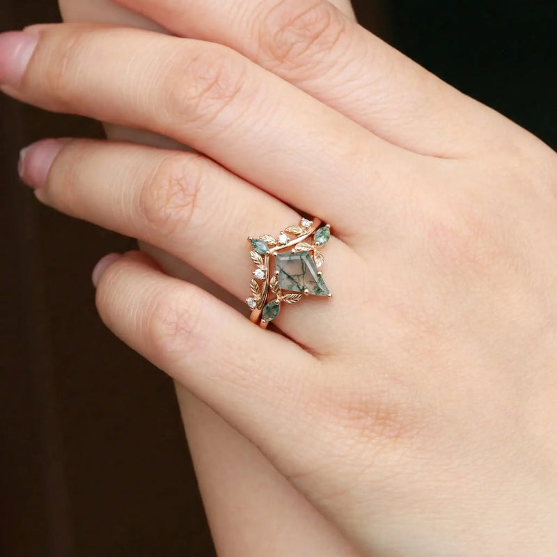 Handcrafted moss agate engagement ring with nature inspired leaf setting rose gold worn on hand showing unique green dendritic patterns organic beauty