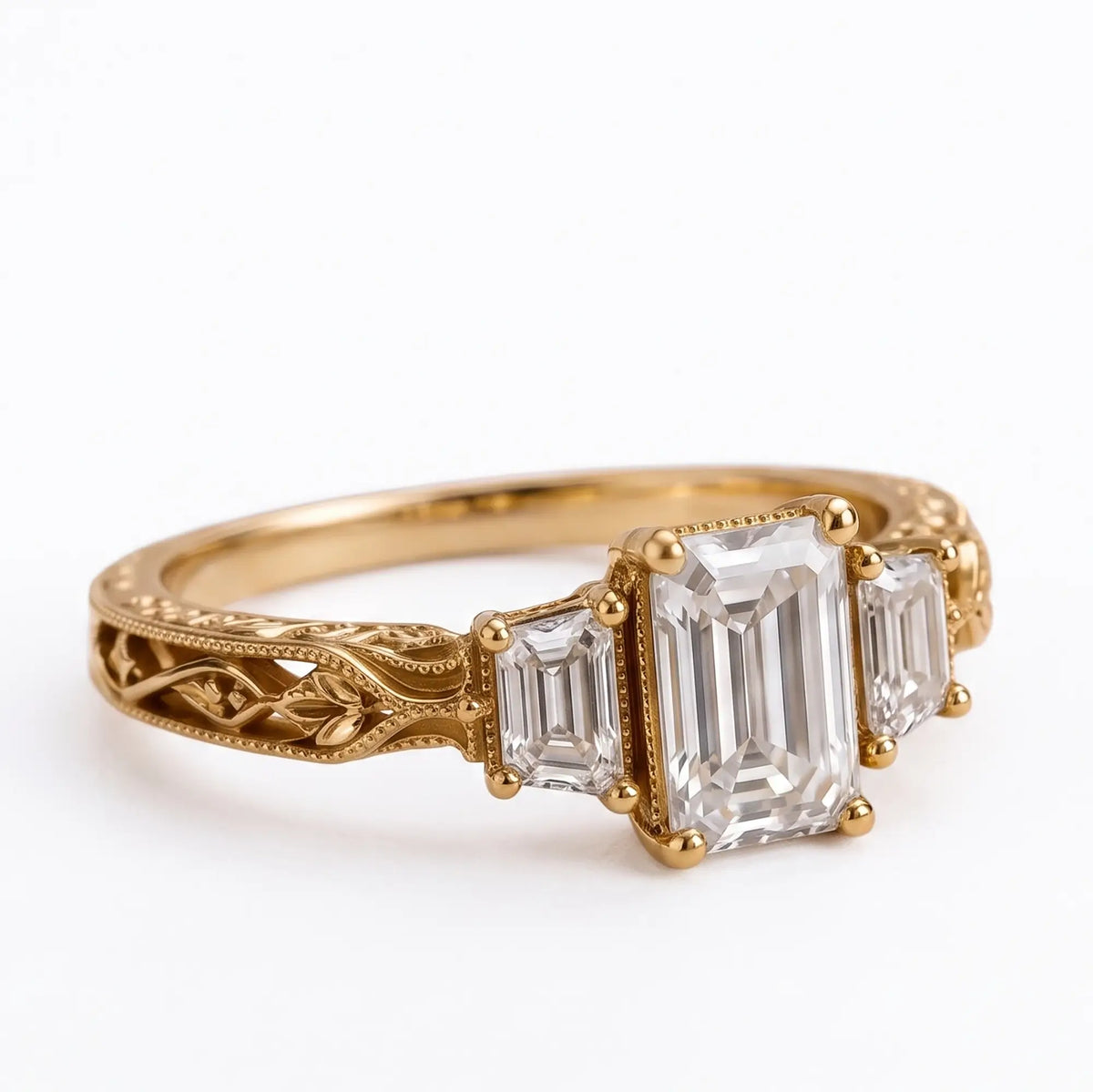 Front view of emerald cut moissanite three stone engagement ring with trapezoid side stones and botanical filigree band