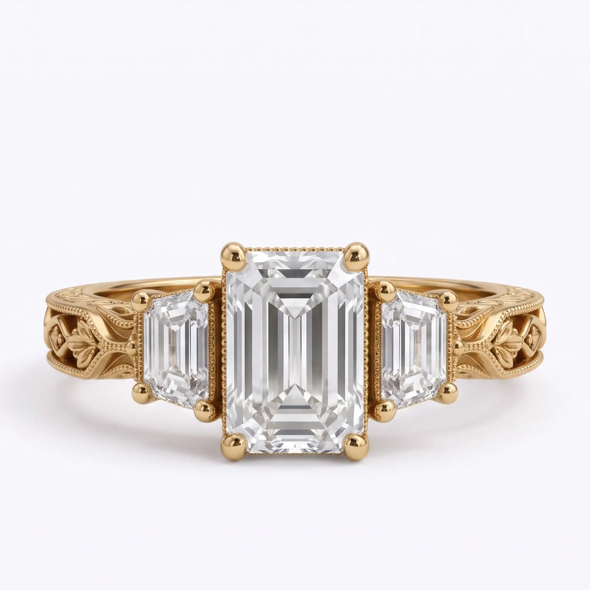 Vintage Art Deco emerald cut moissanite three stone engagement ring with trapezoid side stones and leaf filigree yellow gold band