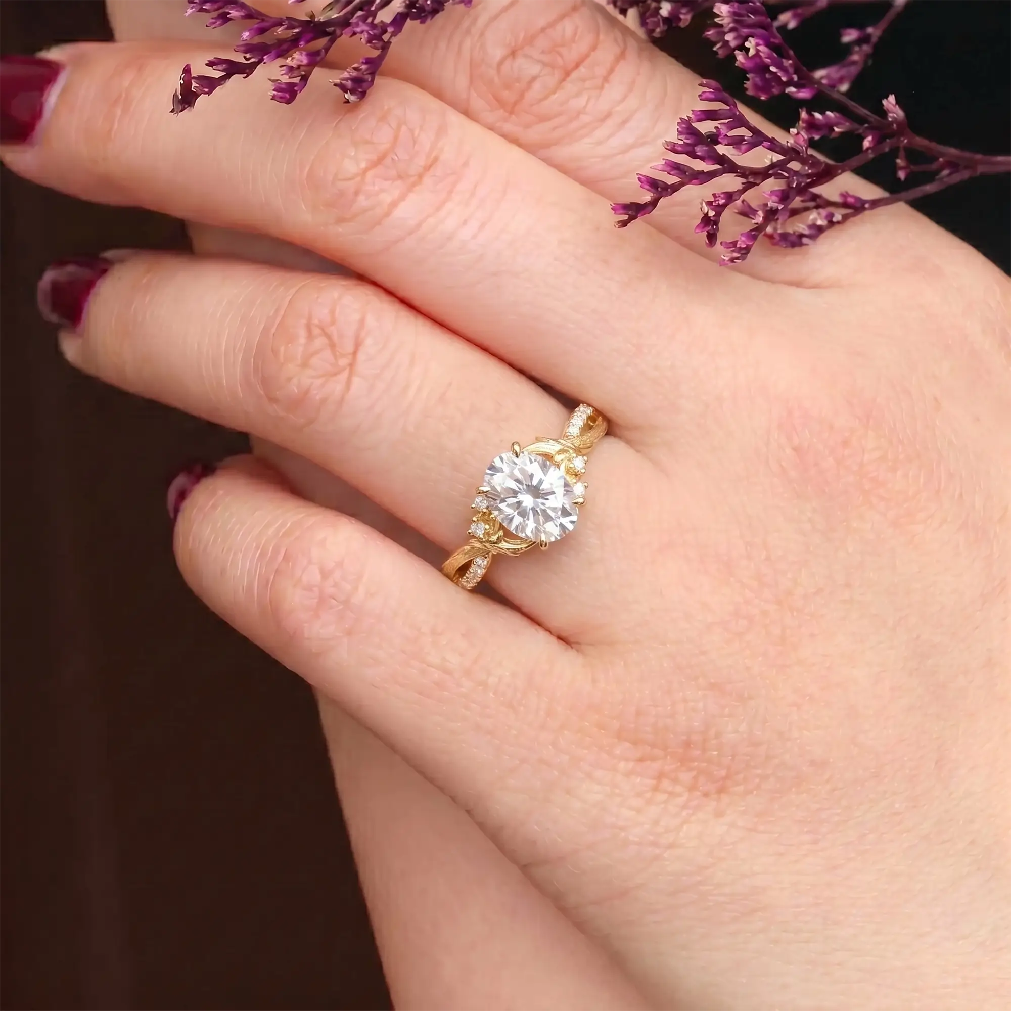 A woman's hand wears a high-end orleone moissanite ring, oval cut, nature-inspired design