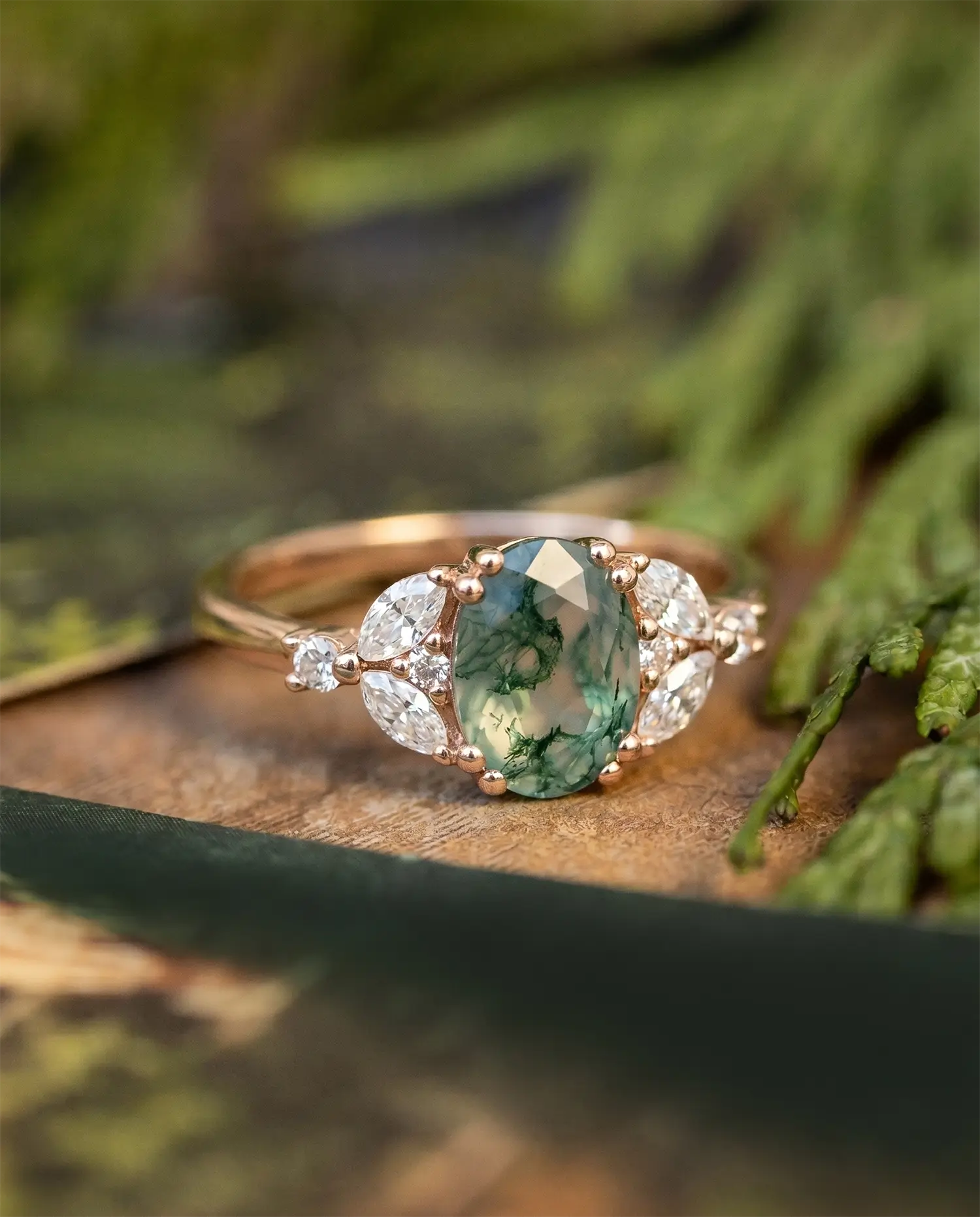 An oval-cut moss agate engagement ring 14k rose gold