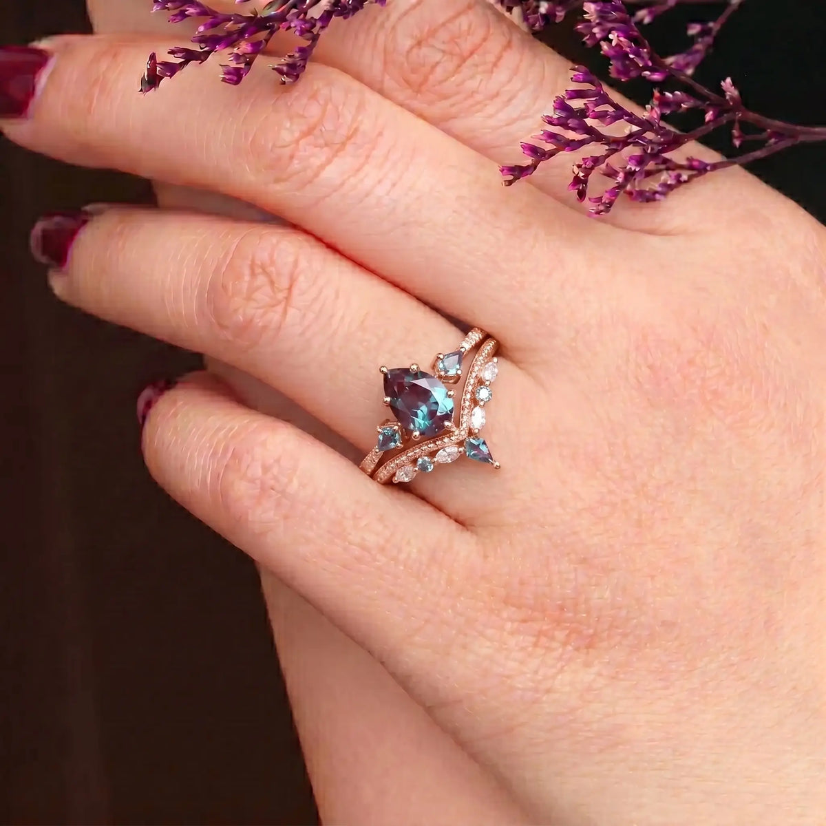 Woman wearing pear alexandrite engagement ring set rose gold vintage design