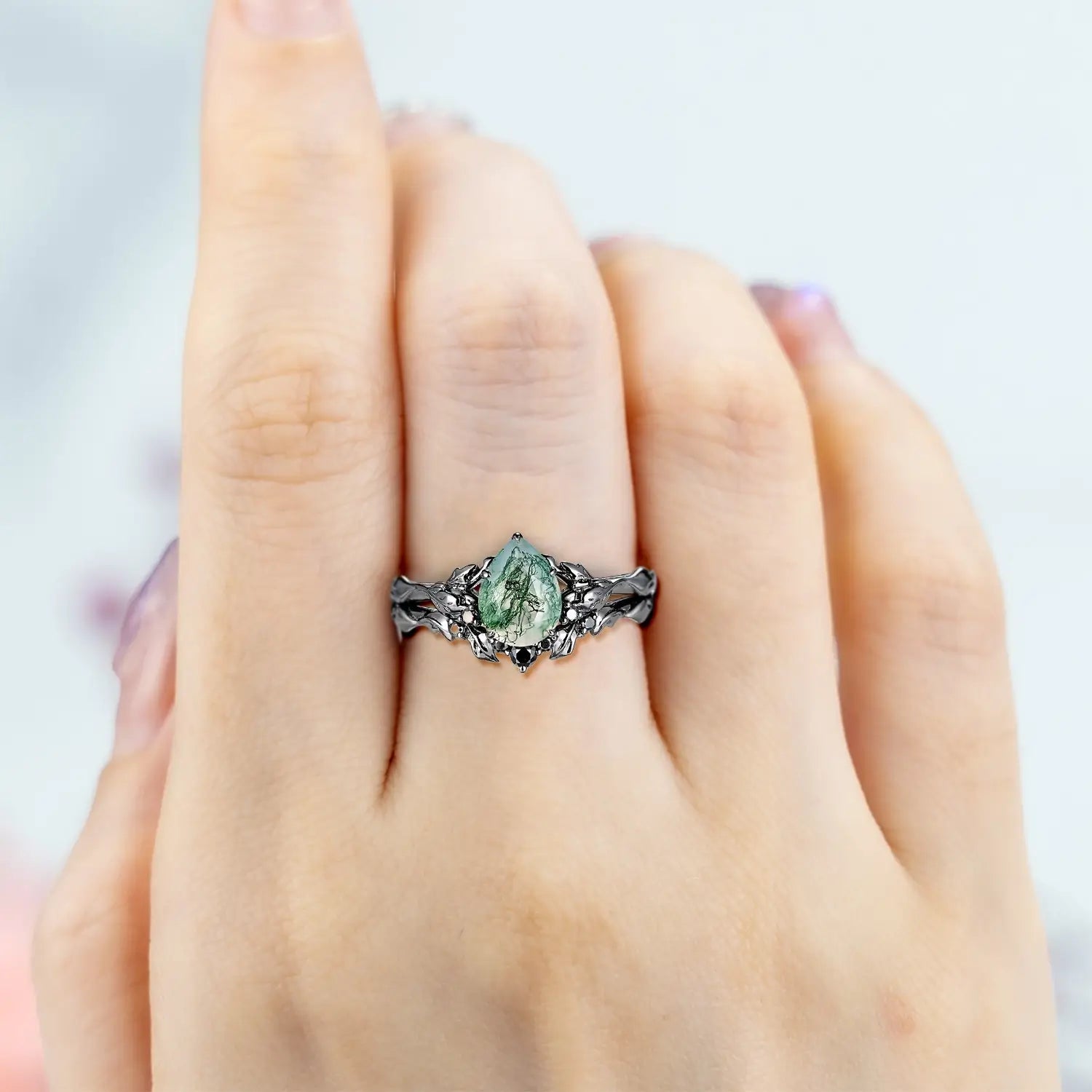Pear moss agate engagement ring set in black gold with onyx accents