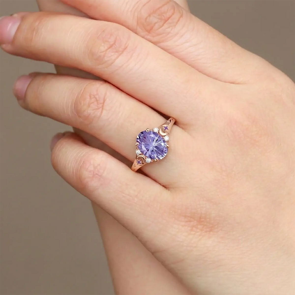 Woman wearing alexandrite moon engagement ring in rose gold 14k