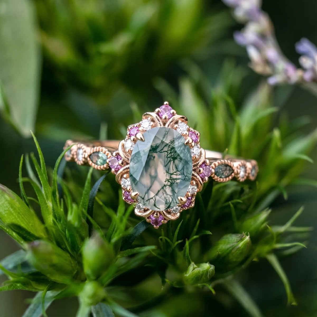 A high-end, custom-made vintage-style halo engagement ring featuring an oval-cut moss agate ring