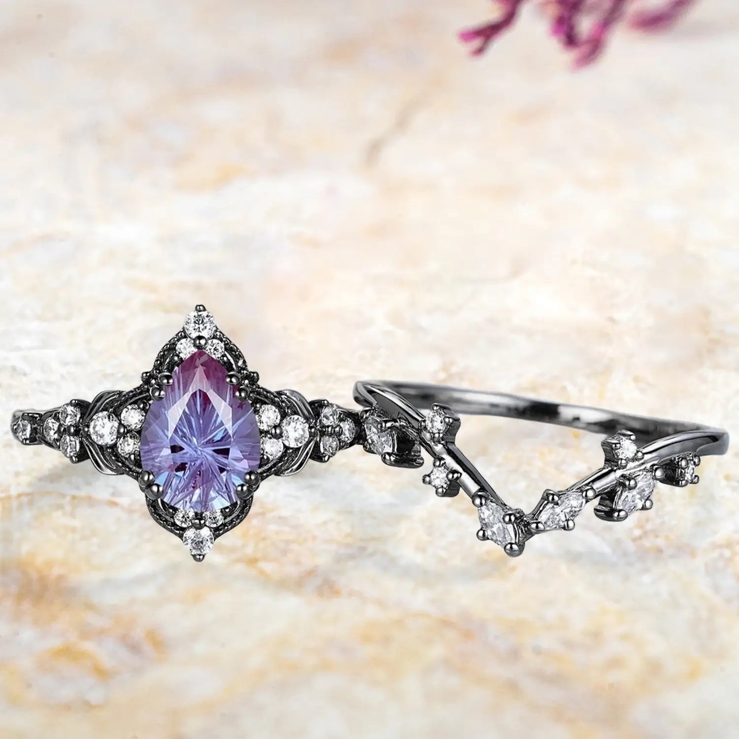 Pear alexandrite fireworks cluster engagement ring and chevron wedding band displayed separately showing unique June birthstone bridal set