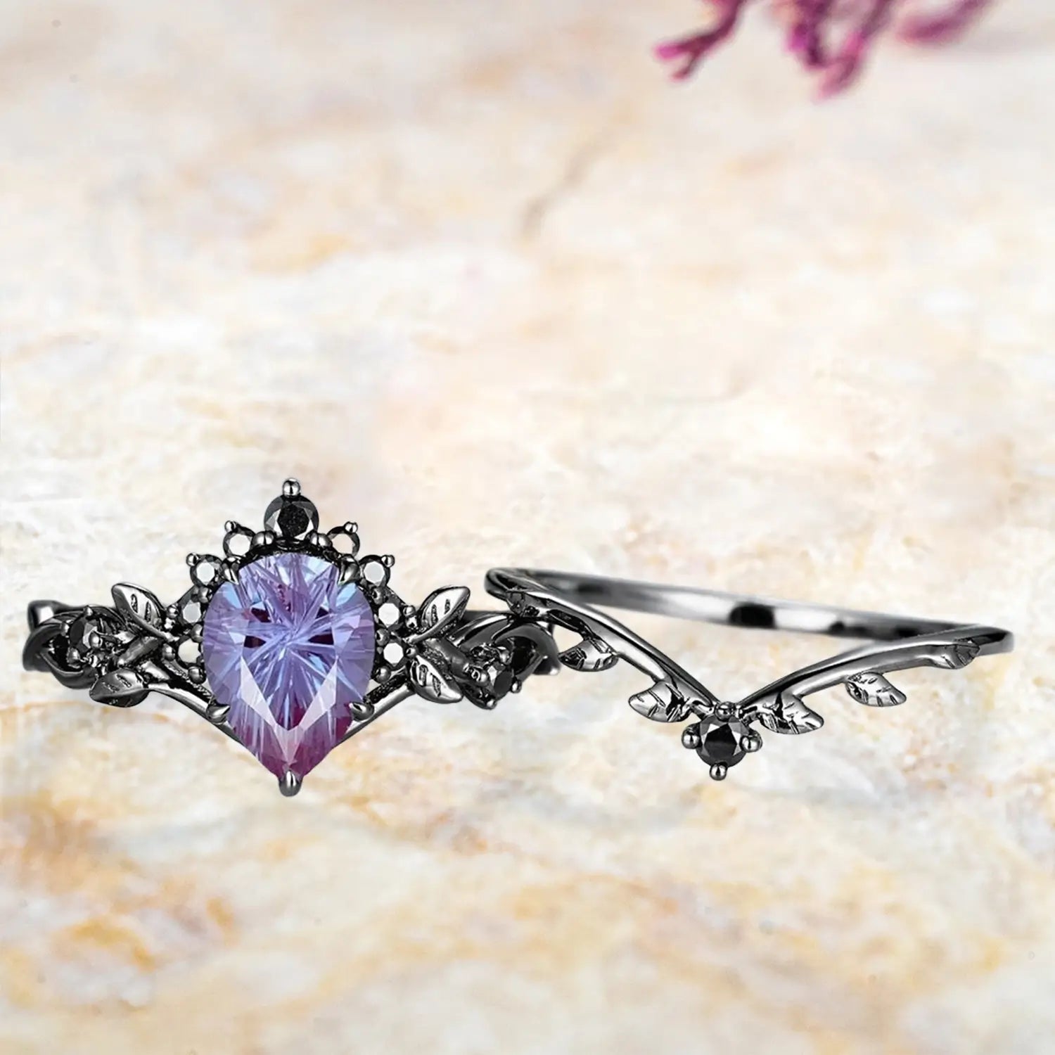 Pear alexandrite Gothic crown engagement ring and curved leaf wedding band displayed separately showing June birthstone bridal set