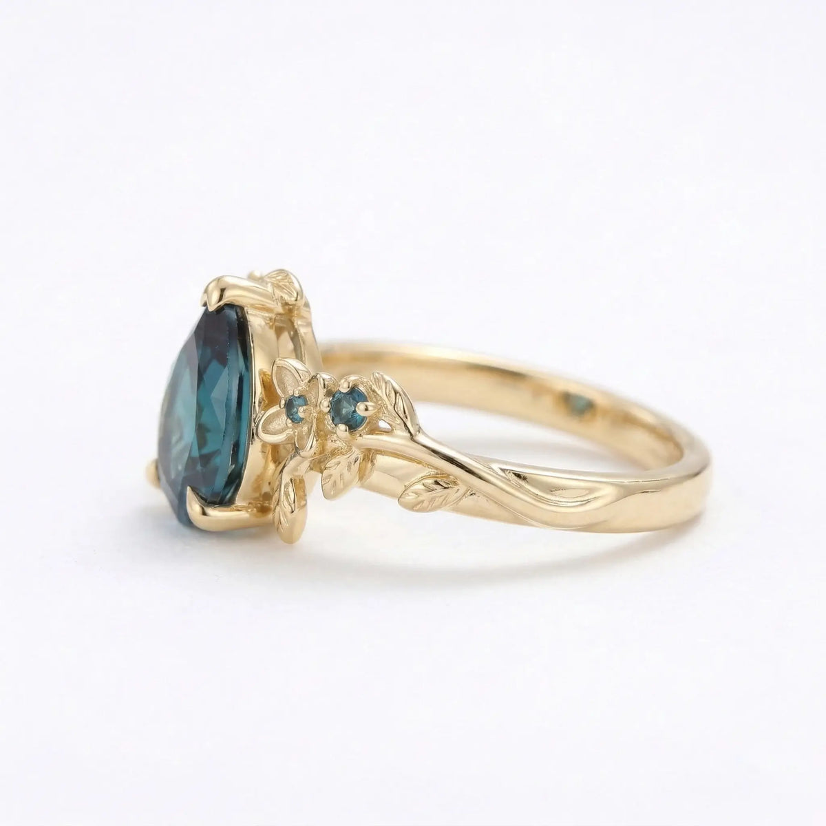 Side view of pear cut alexandrite leaf engagement ring