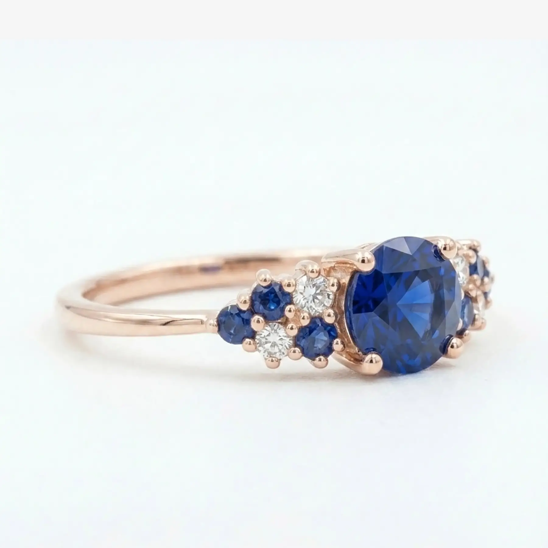 Unique alternative bridal gemstone ring with multi-prong cluster setting in solid gold.