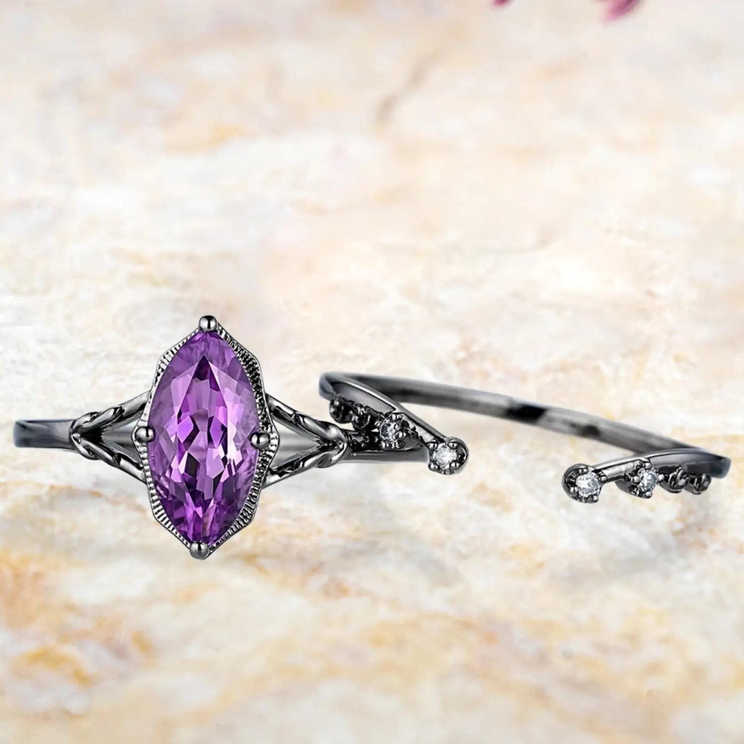 Marquise amethyst split shank engagement ring and curved wedding band displayed separately showing unique Gothic bridal set