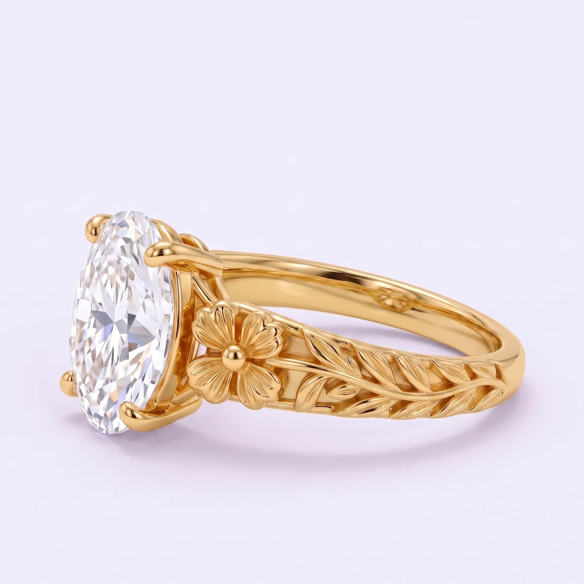 Angled side view of Avelune oval lab diamond ring showing a sculpted gold flower, veined leaf detailing and prong setting.