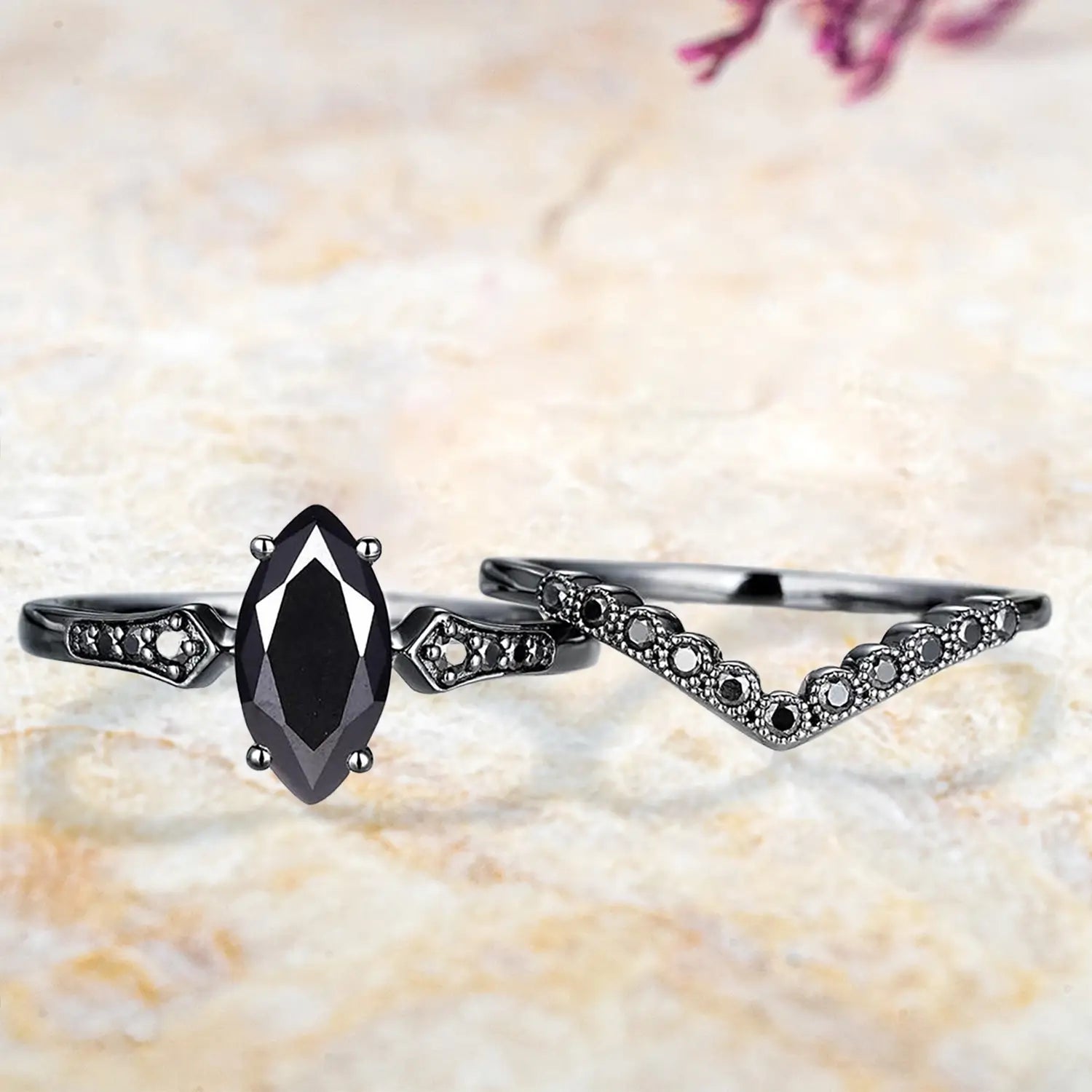 Marquise black onyx vintage engagement ring and chevron wedding band displayed separately showing unique Gothic bridal set