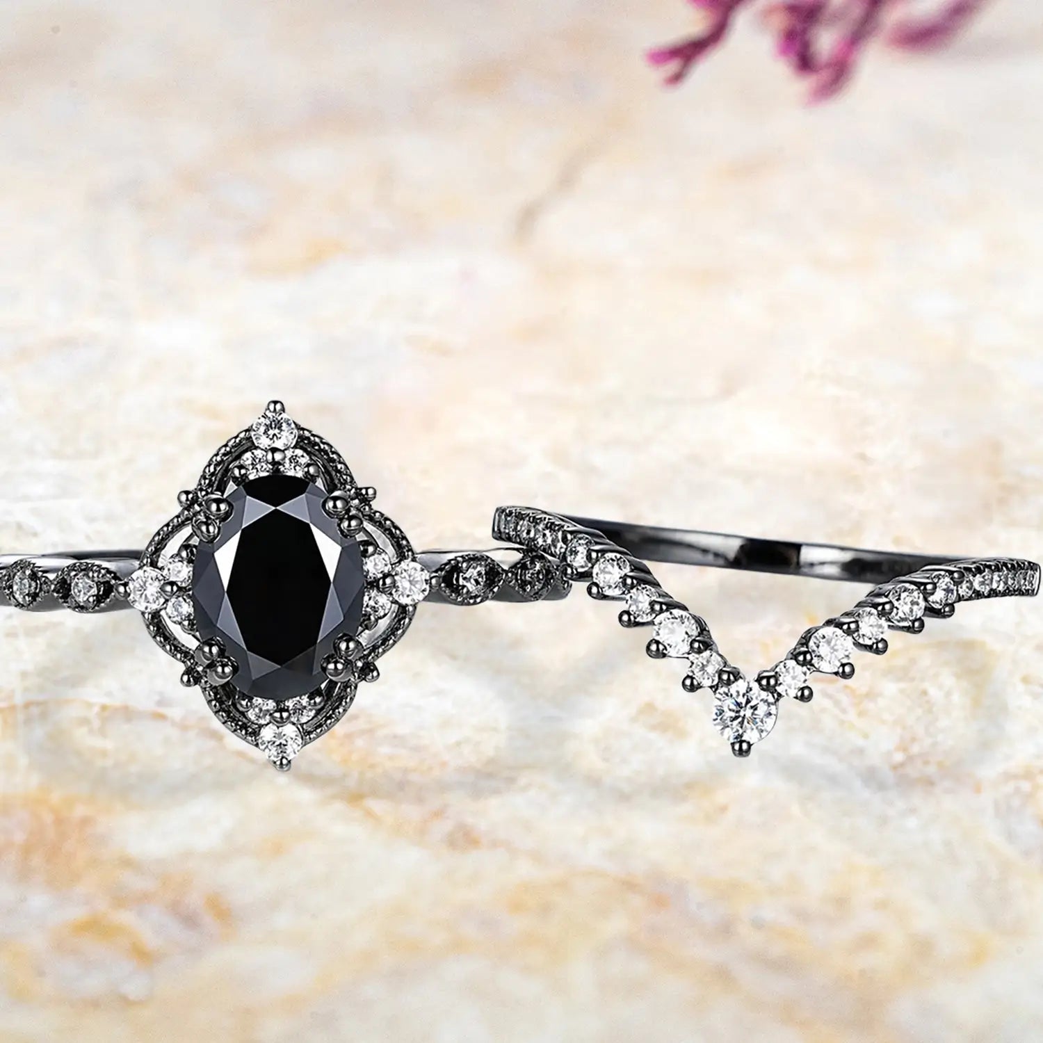 Oval black onyx crown cluster engagement ring and chevron diamond wedding band displayed separately showing Gothic bridal set