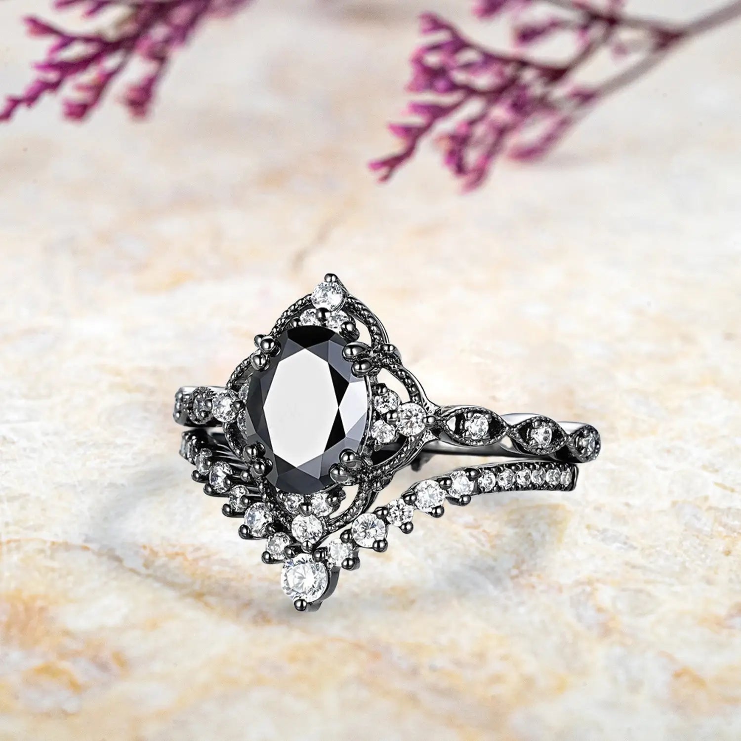 Side view of oval black onyx ring showing vintage crown cluster halo and chevron wedding band profile