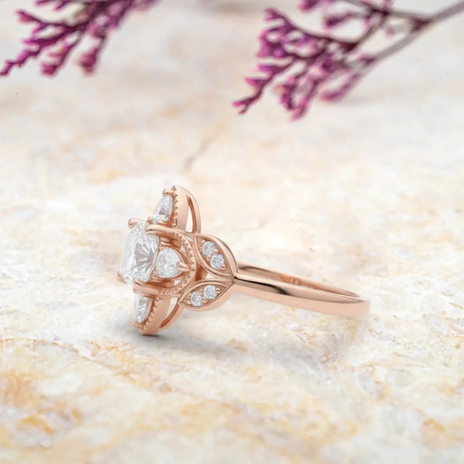 Close up detail of cushion moissanite center stone with four leaf clover pear halo and vintage milgrain