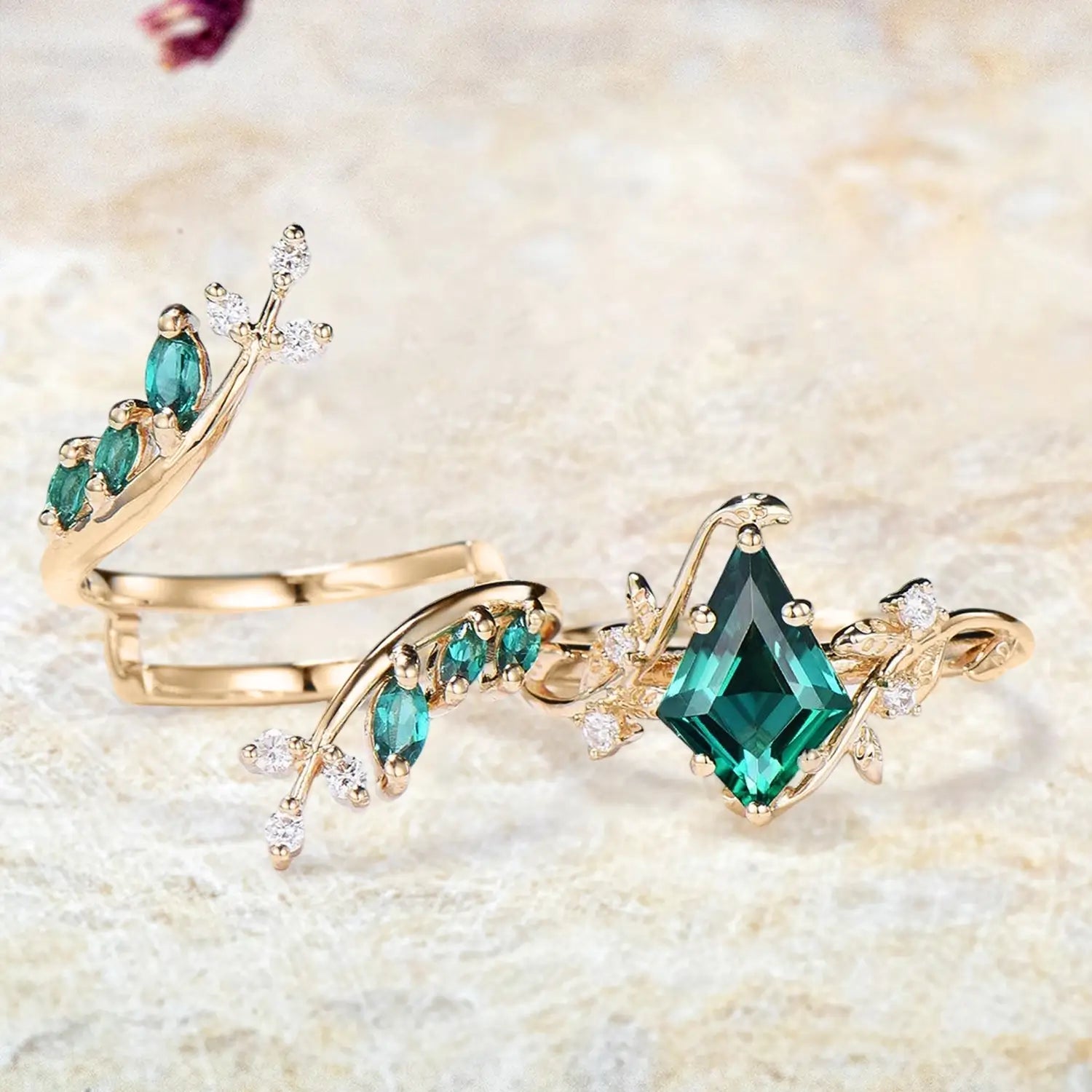 Kite emerald engagement ring and curved leafy wedding band separated bridal set