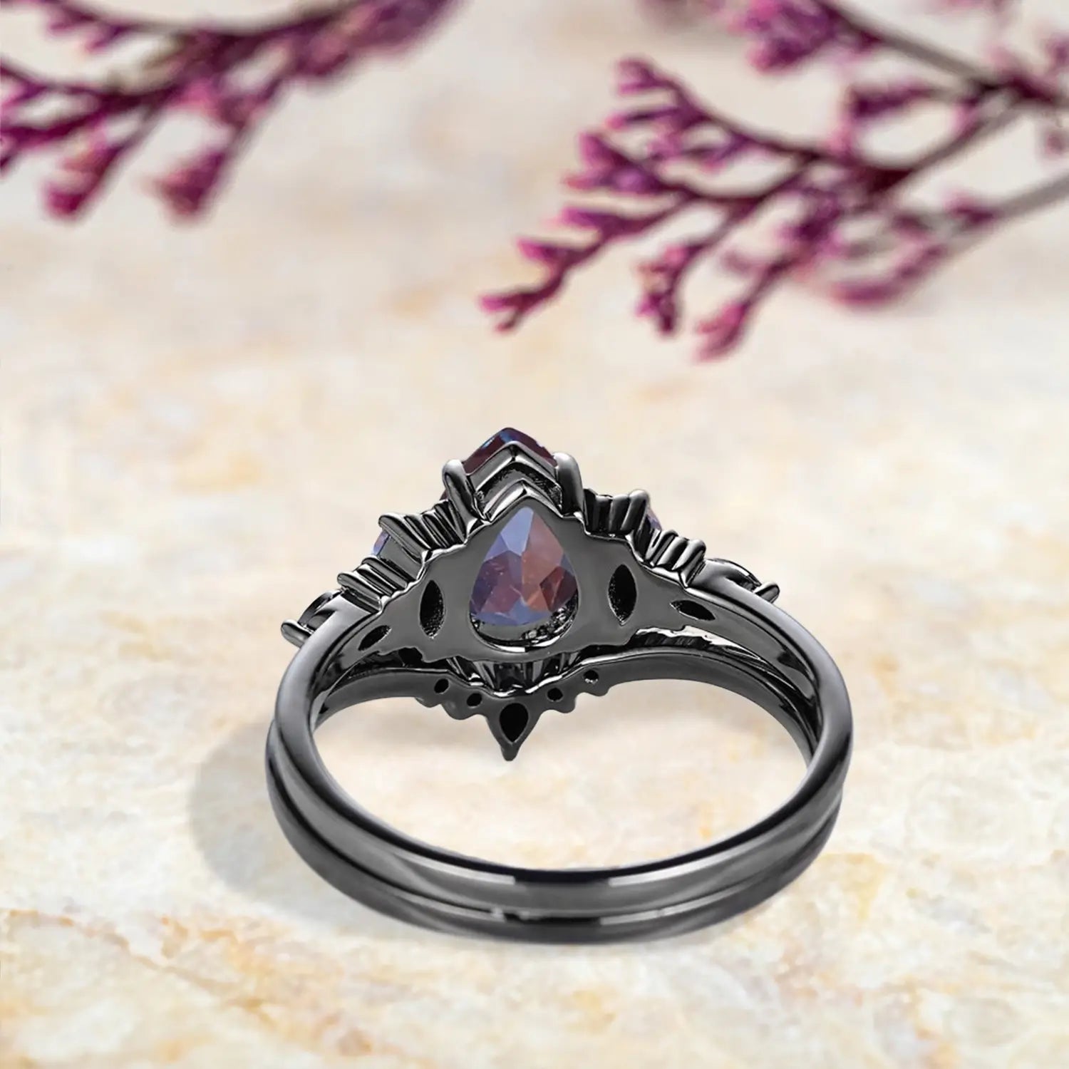 Back view of Gothic alexandrite engagement ring set showing cluster design and curved chevron wedding band craftsmanship in black gold